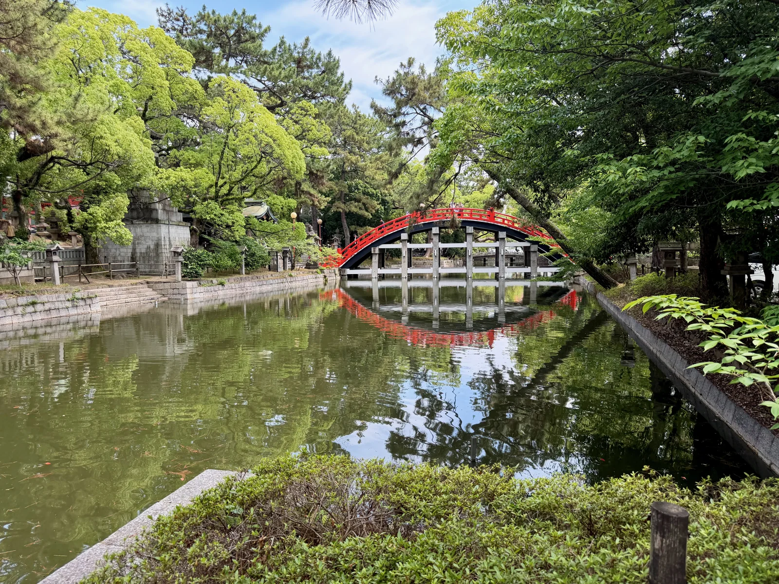 The red arched bridge at Sumiyoshi Taisha reflected in the pond.