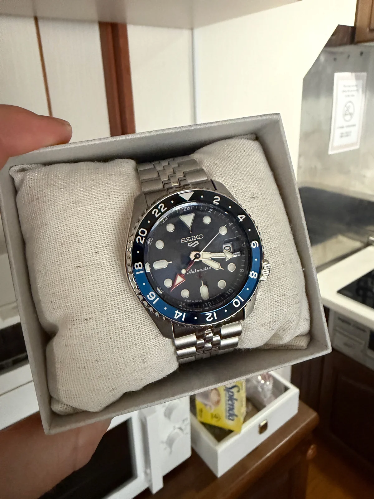 A blue-and-black watch in its presentation box.