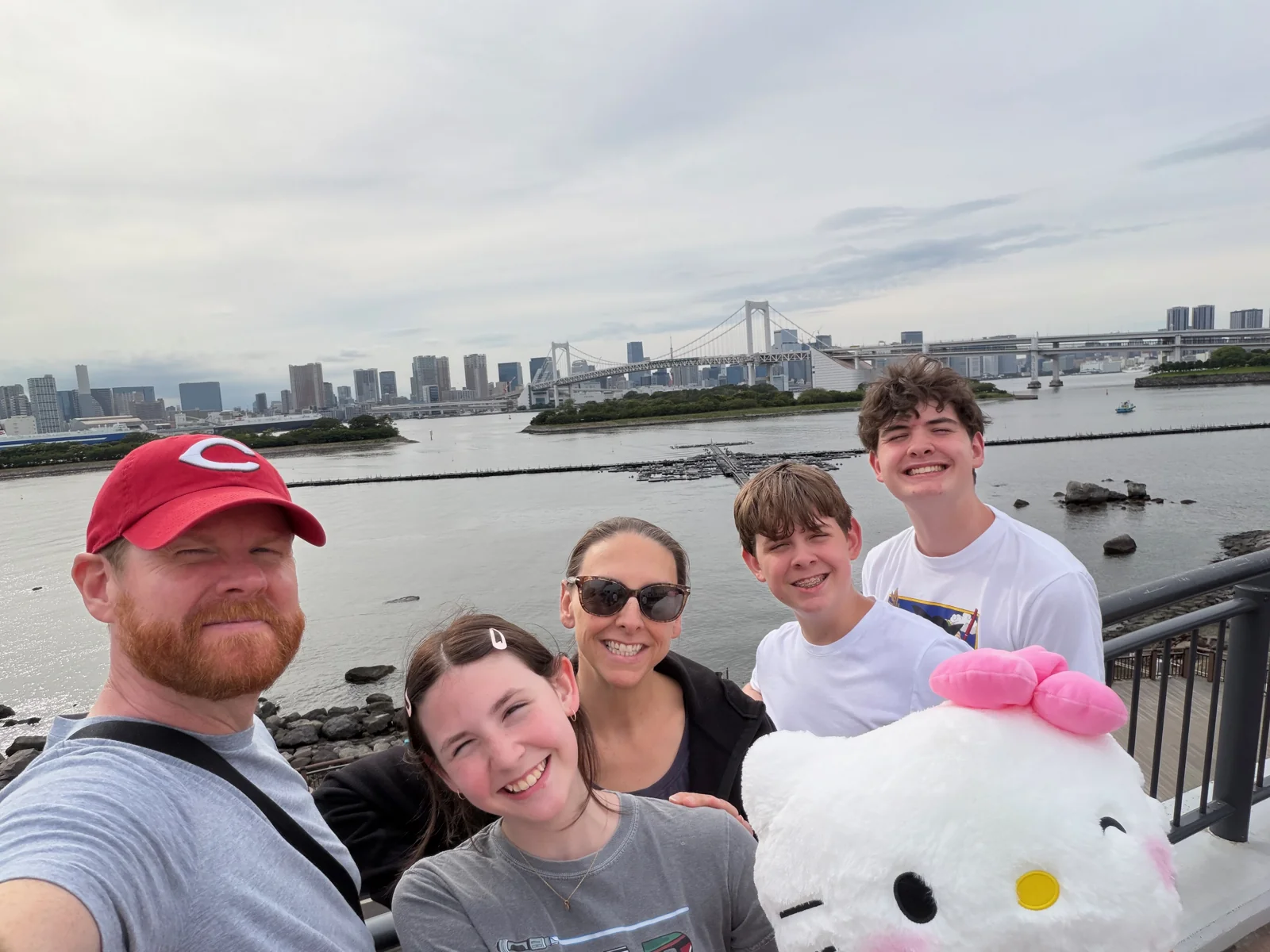 The family with a large Hello Kitty plush at the Odaiba waterfront.