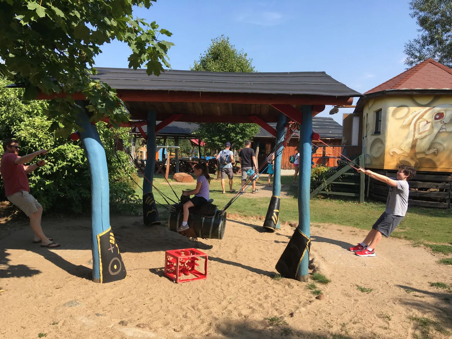 Children playing on a wooden playground structure