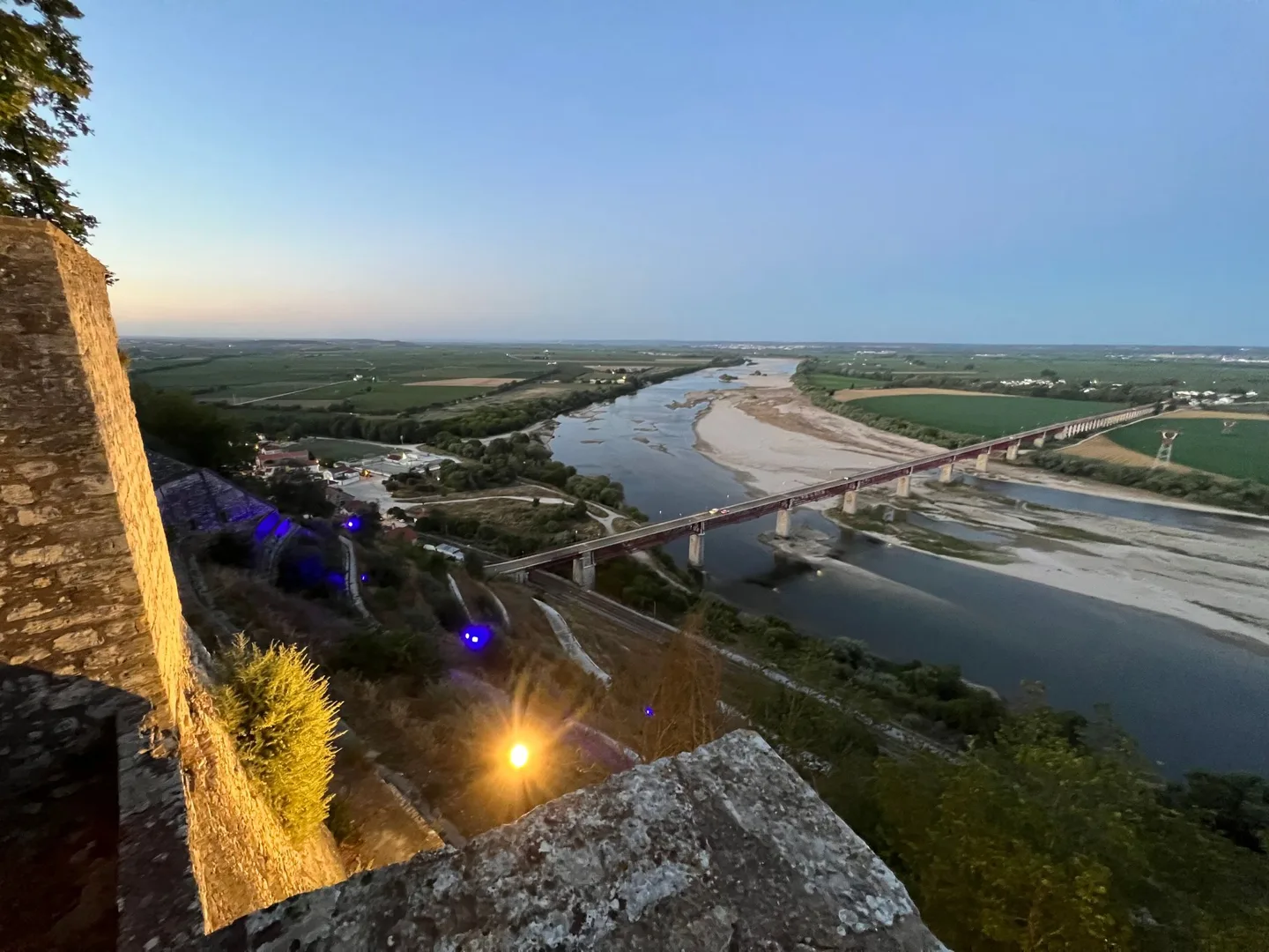 River and farmland viewed from a terrace at dusk