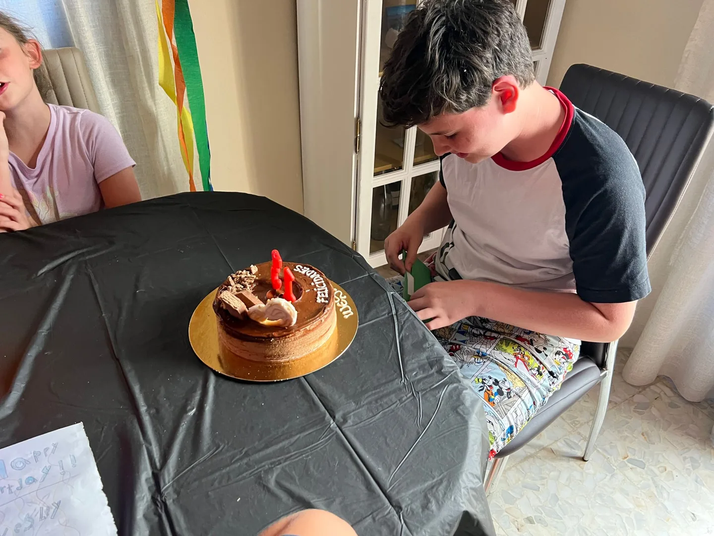 Birthday cake on the table beside a child