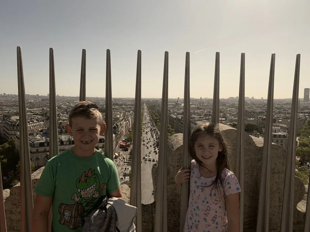 Children at a rooftop viewpoint above Paris