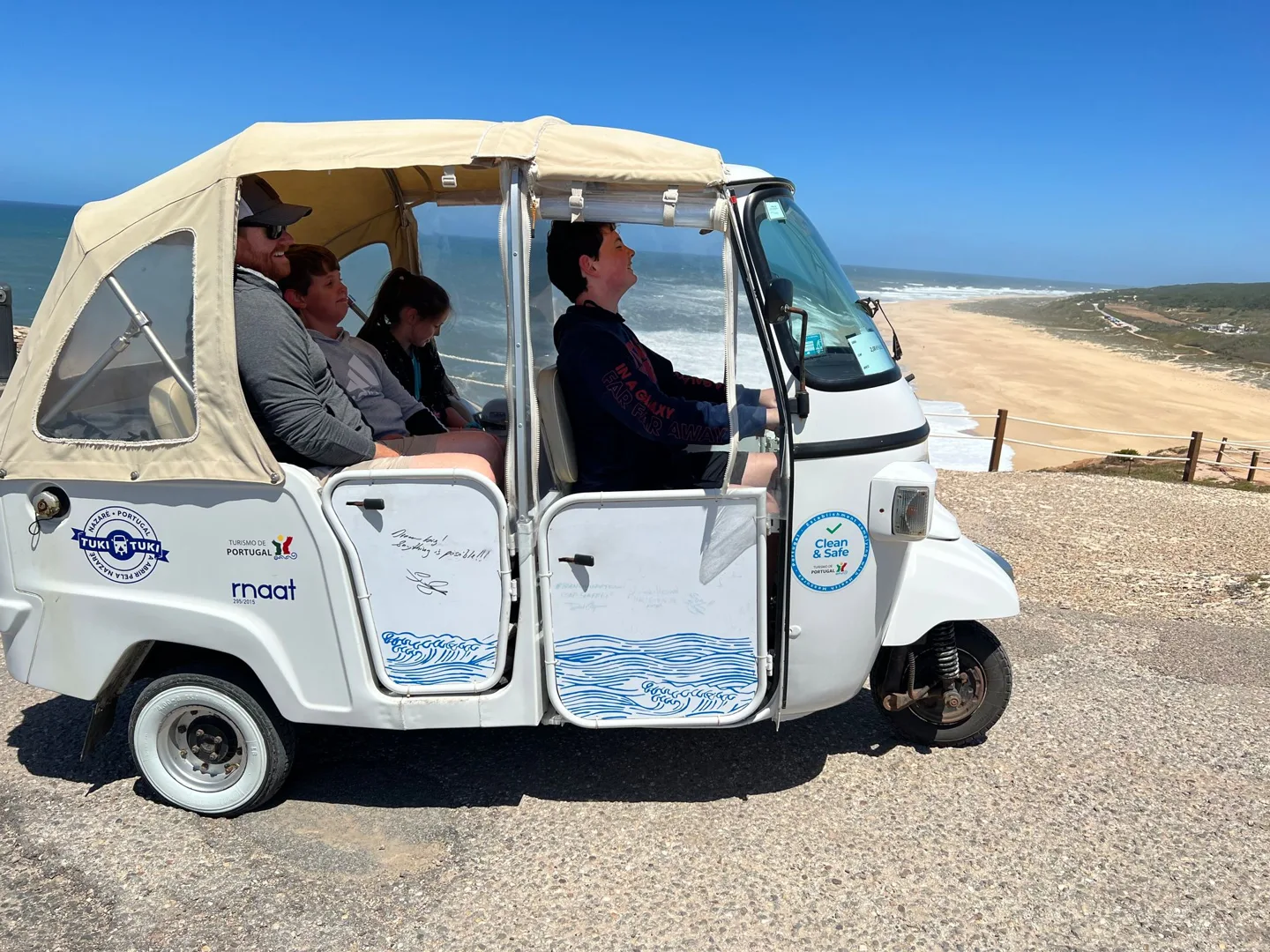 Family seated in a small sightseeing vehicle