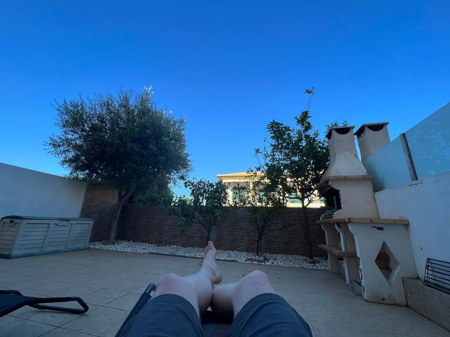 Relaxing on a sunny terrace beside white walls