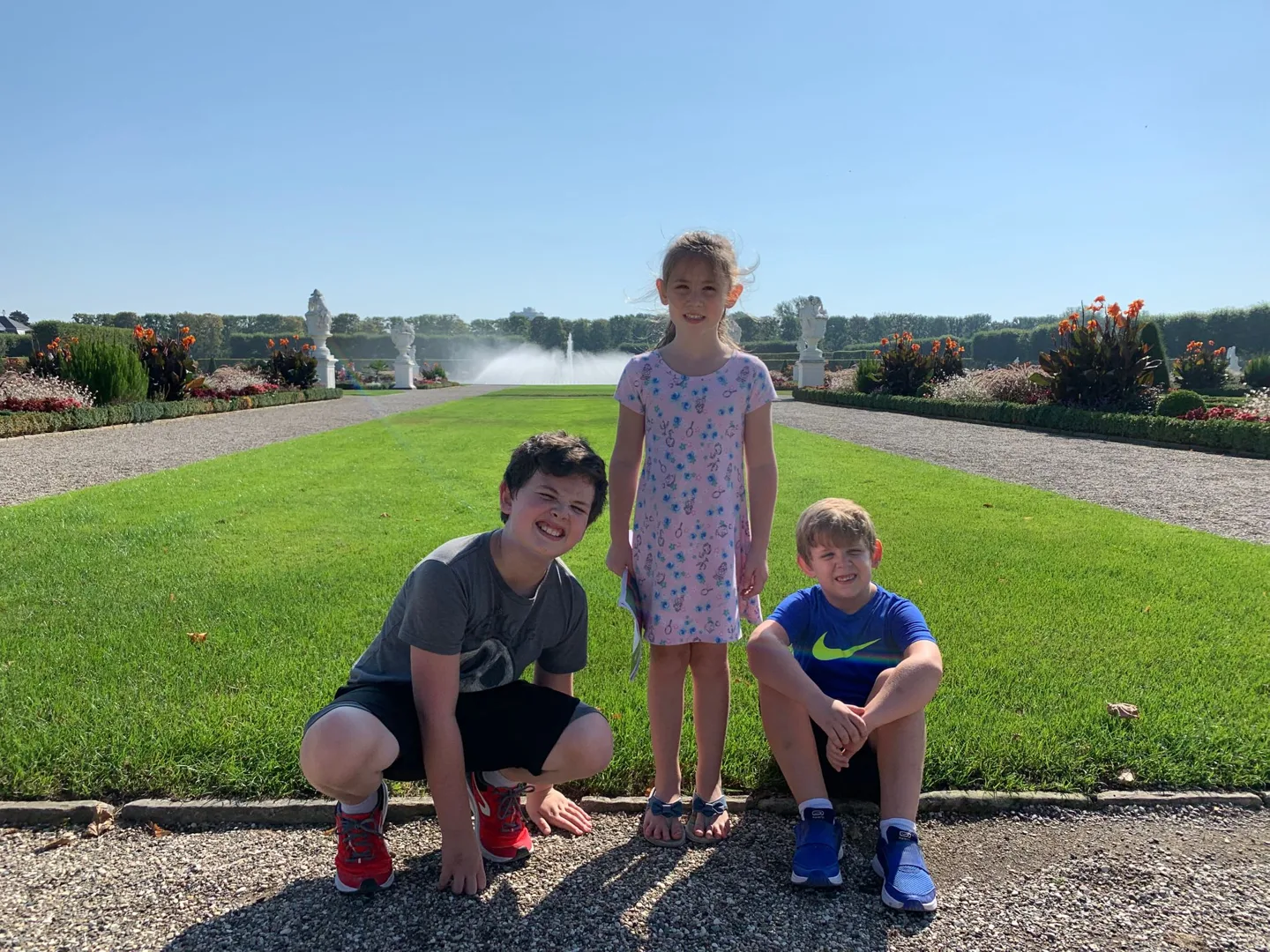 Children posing beside the formal gardens