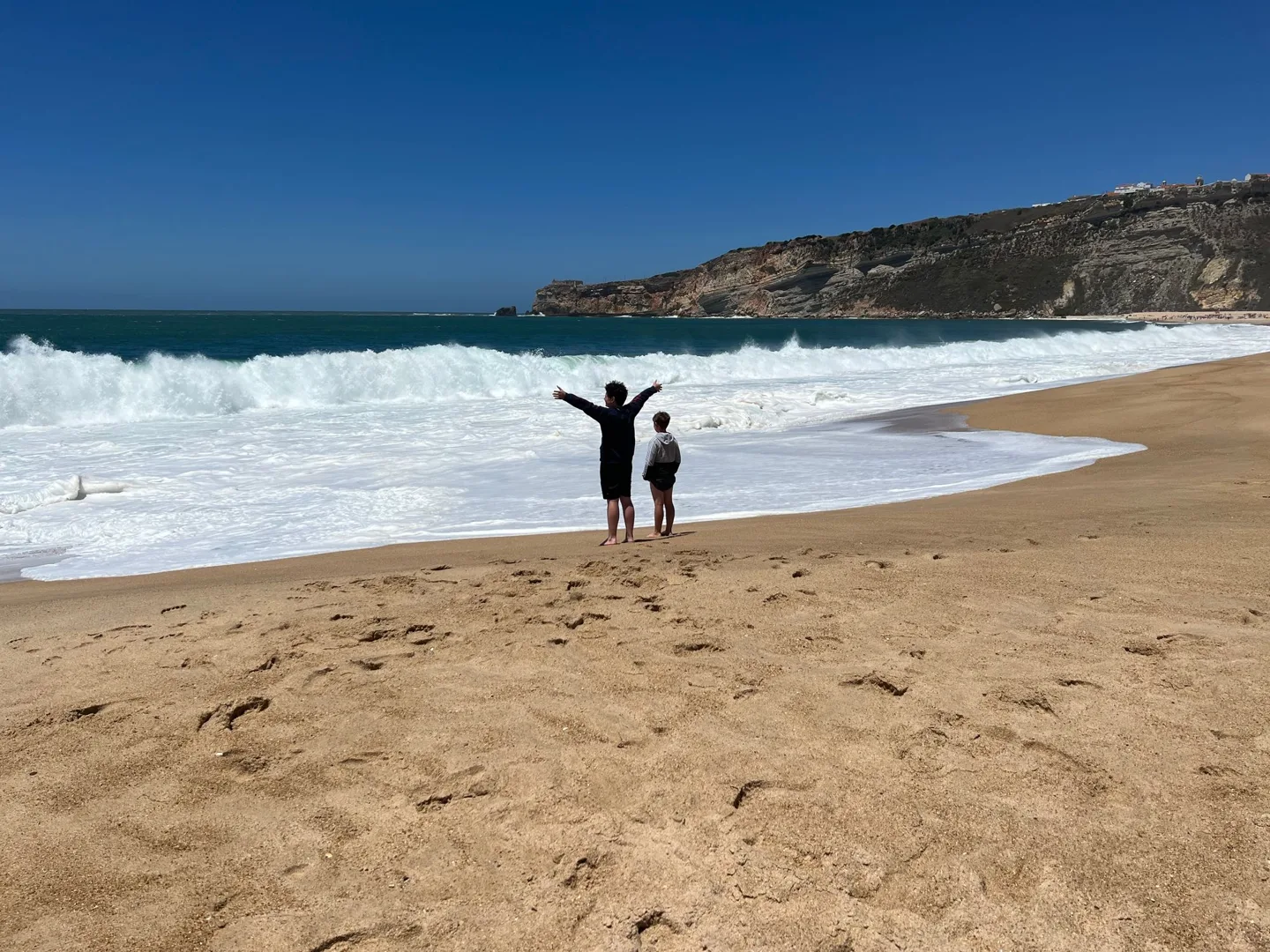 Children playing at the water's edge