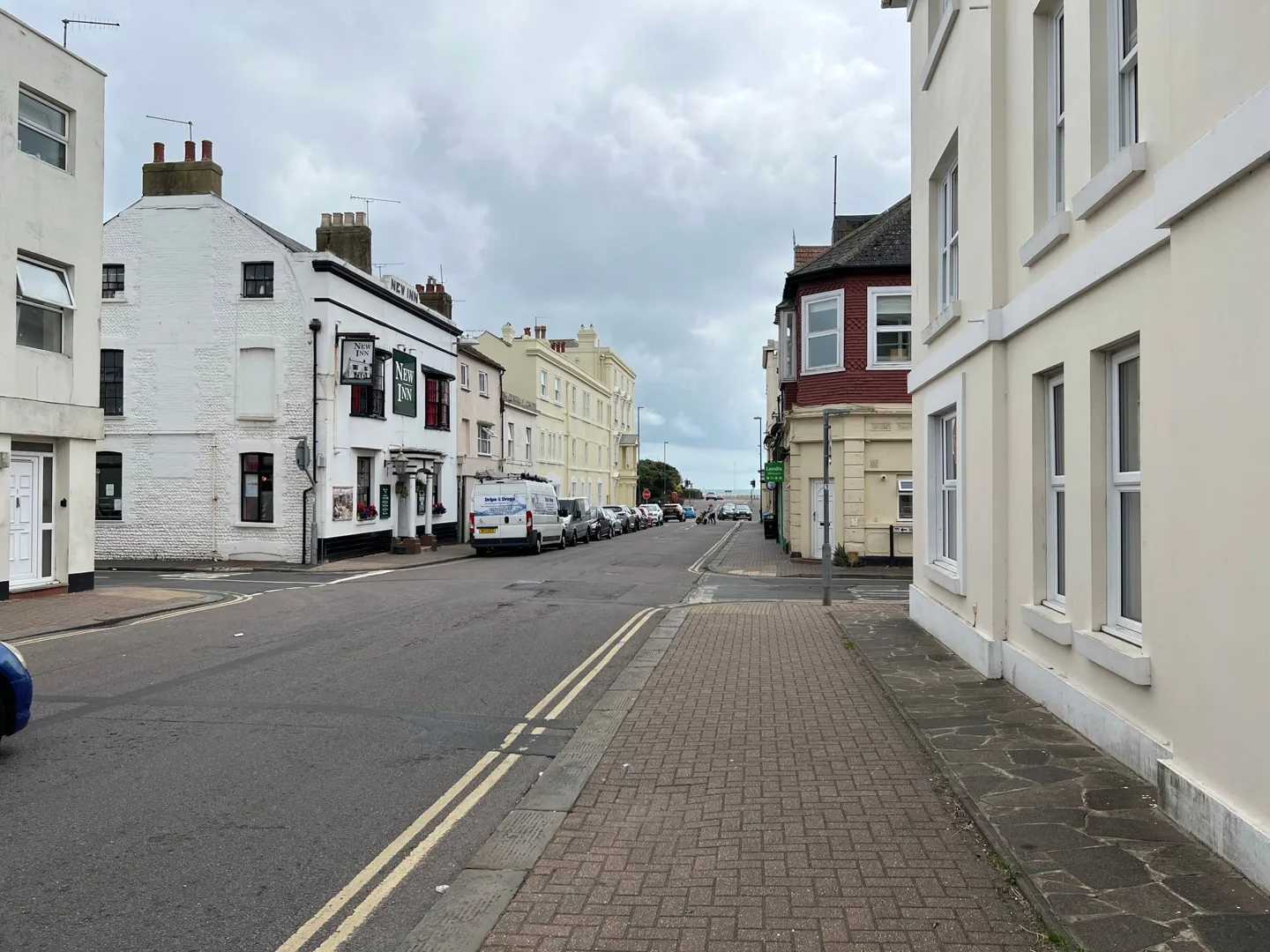 Quiet street lined with white buildings