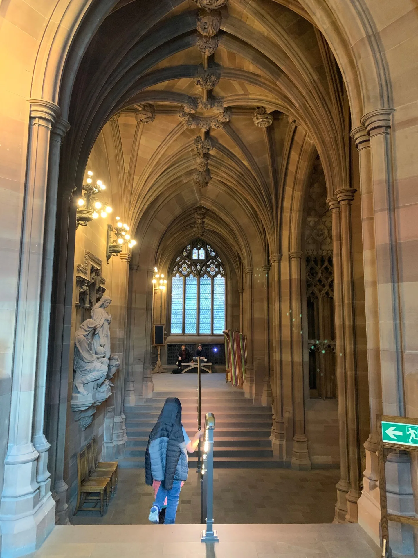Tall stone arches and windows inside the library