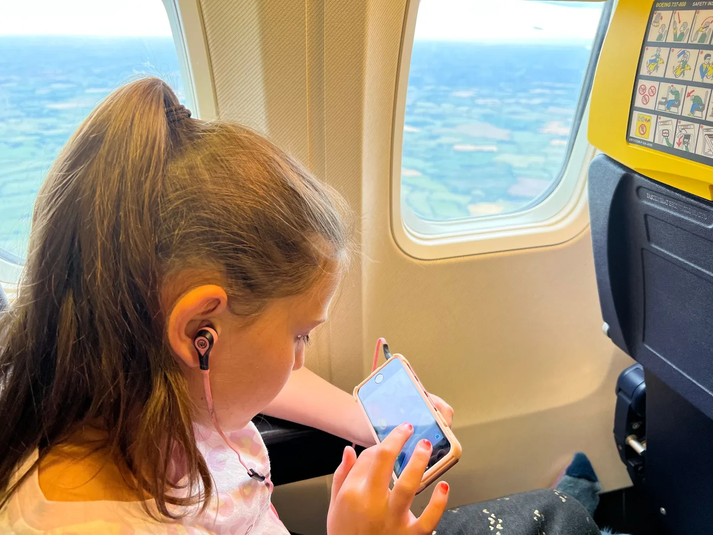 Child watching a device on the flight