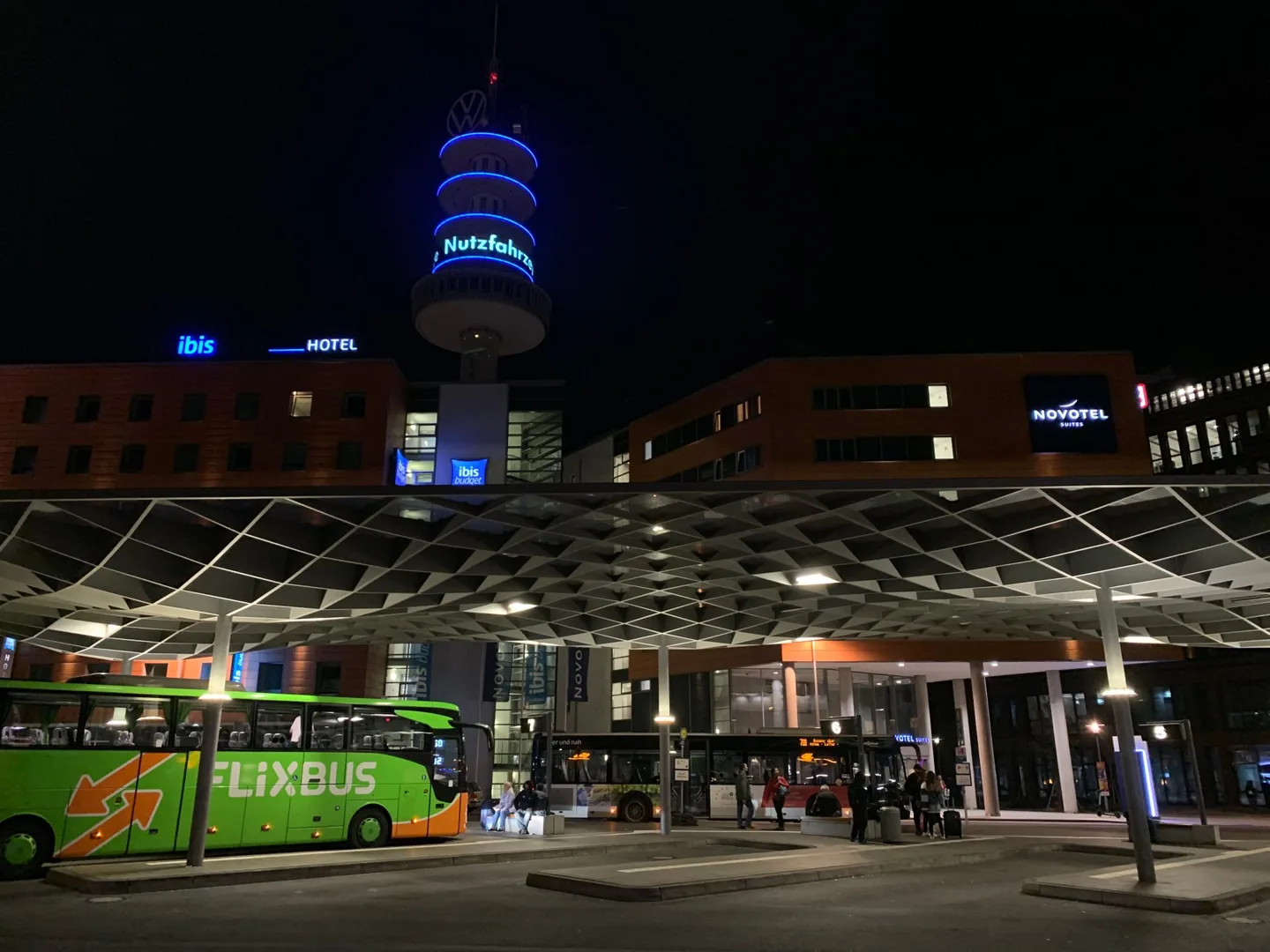 City square and illuminated tower at night