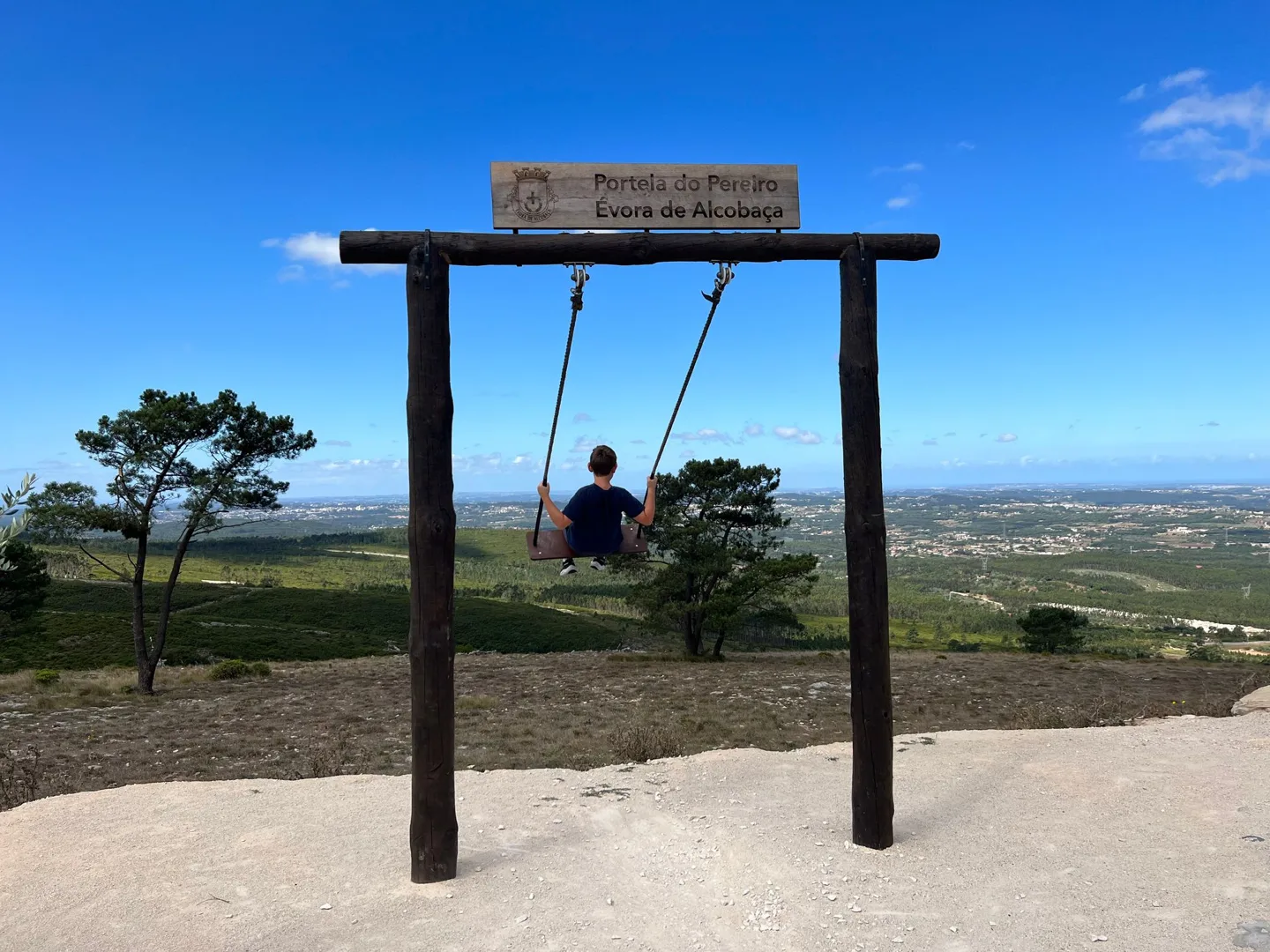 Large wooden swing above the countryside