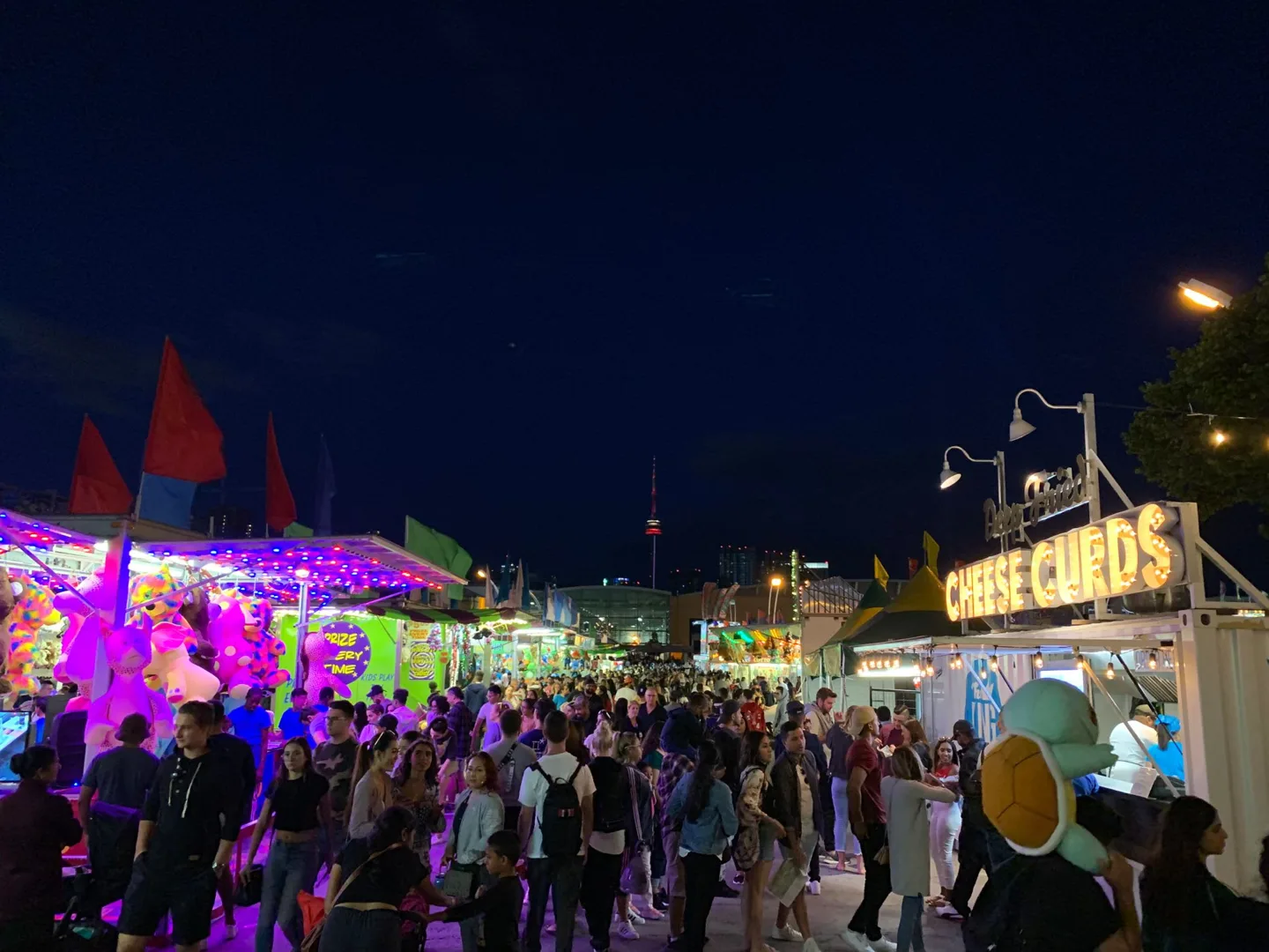 Colorful lights and crowds at a nighttime fair