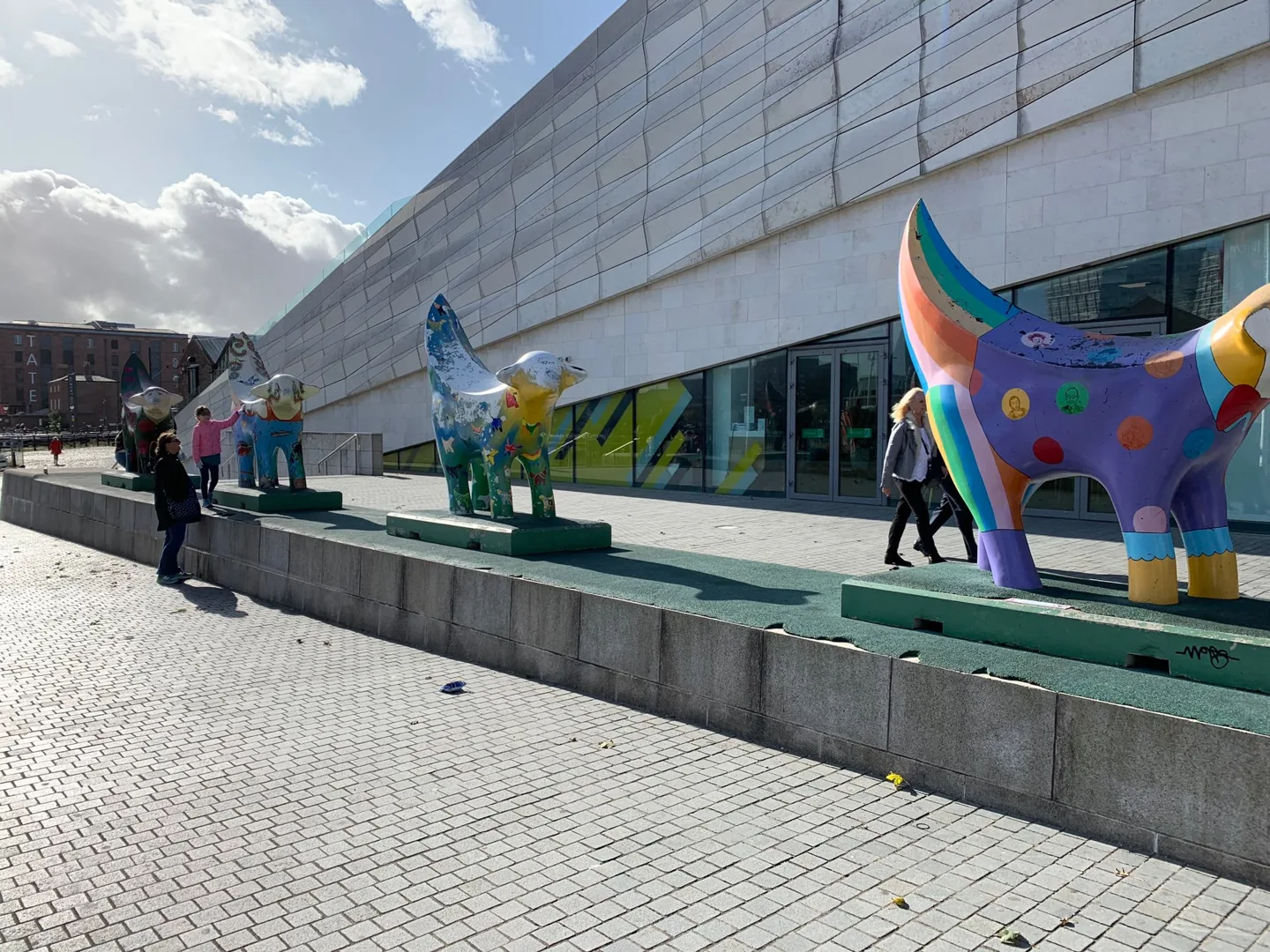 Colorful sculpture outside a modern waterfront building