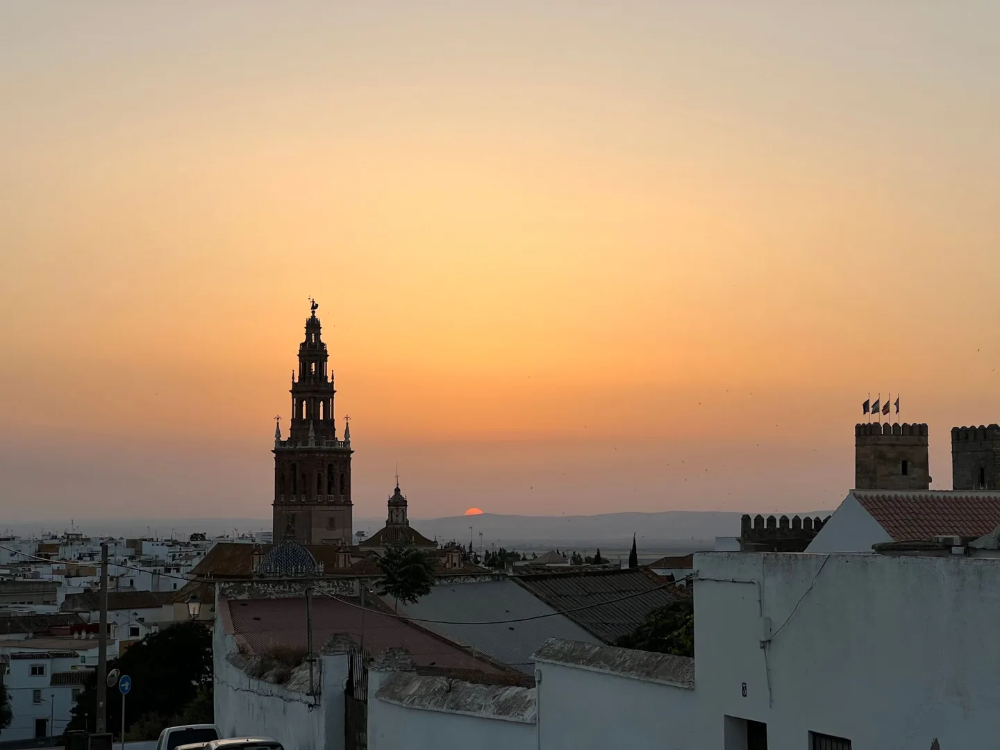 Church tower silhouetted against a warm evening sky
