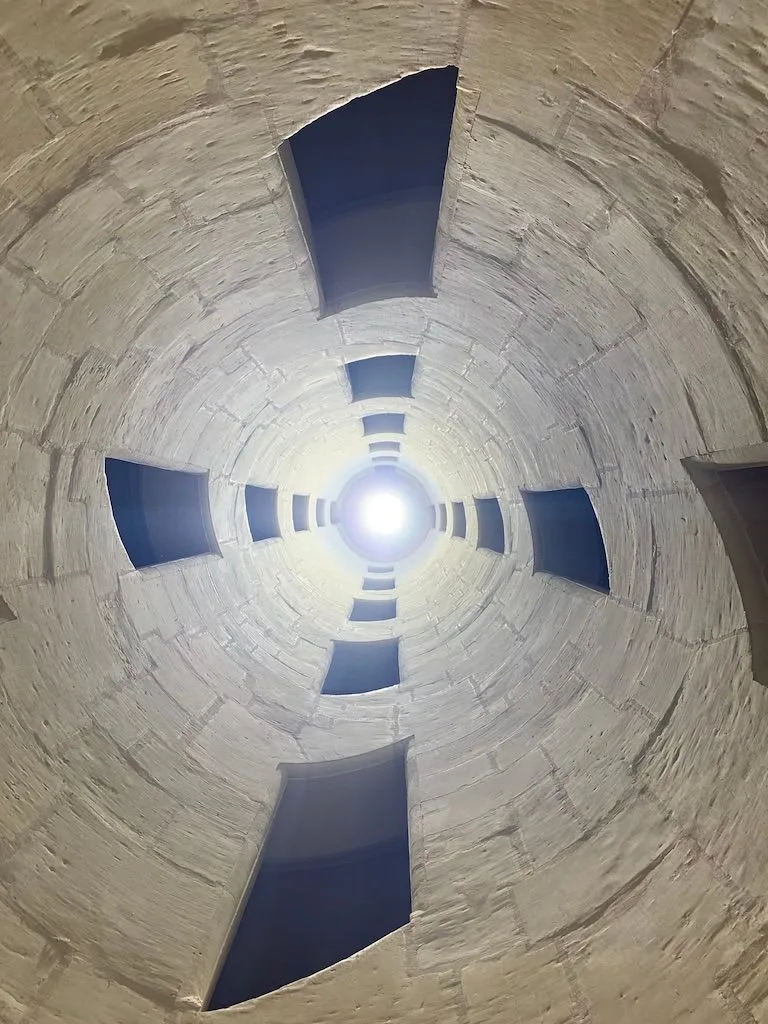 Looking upward inside a stone staircase