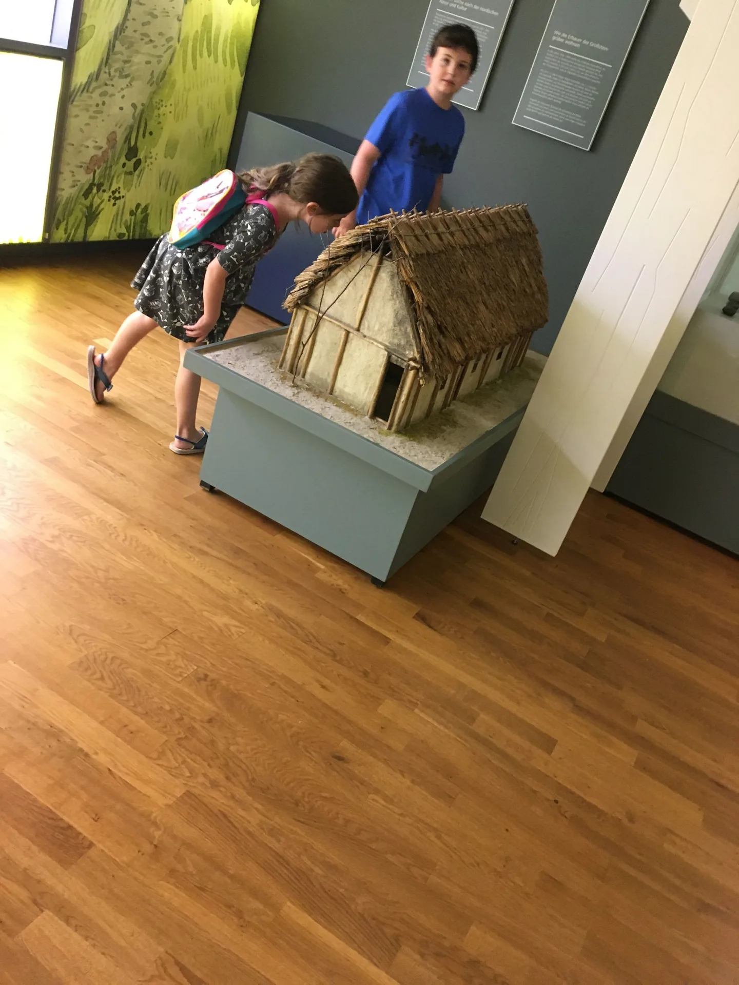 Child seated inside a museum display