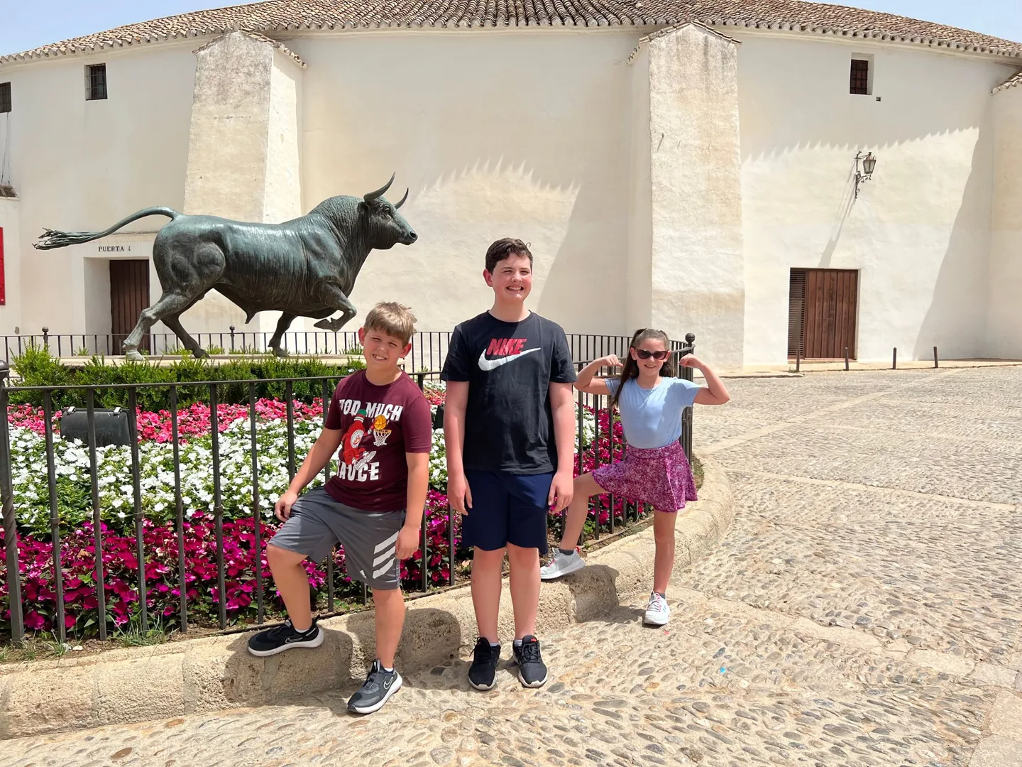 Children beside a bull statue in Ronda