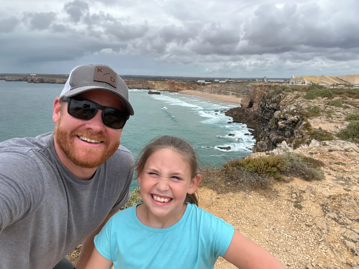 Father and daughter above the coastline