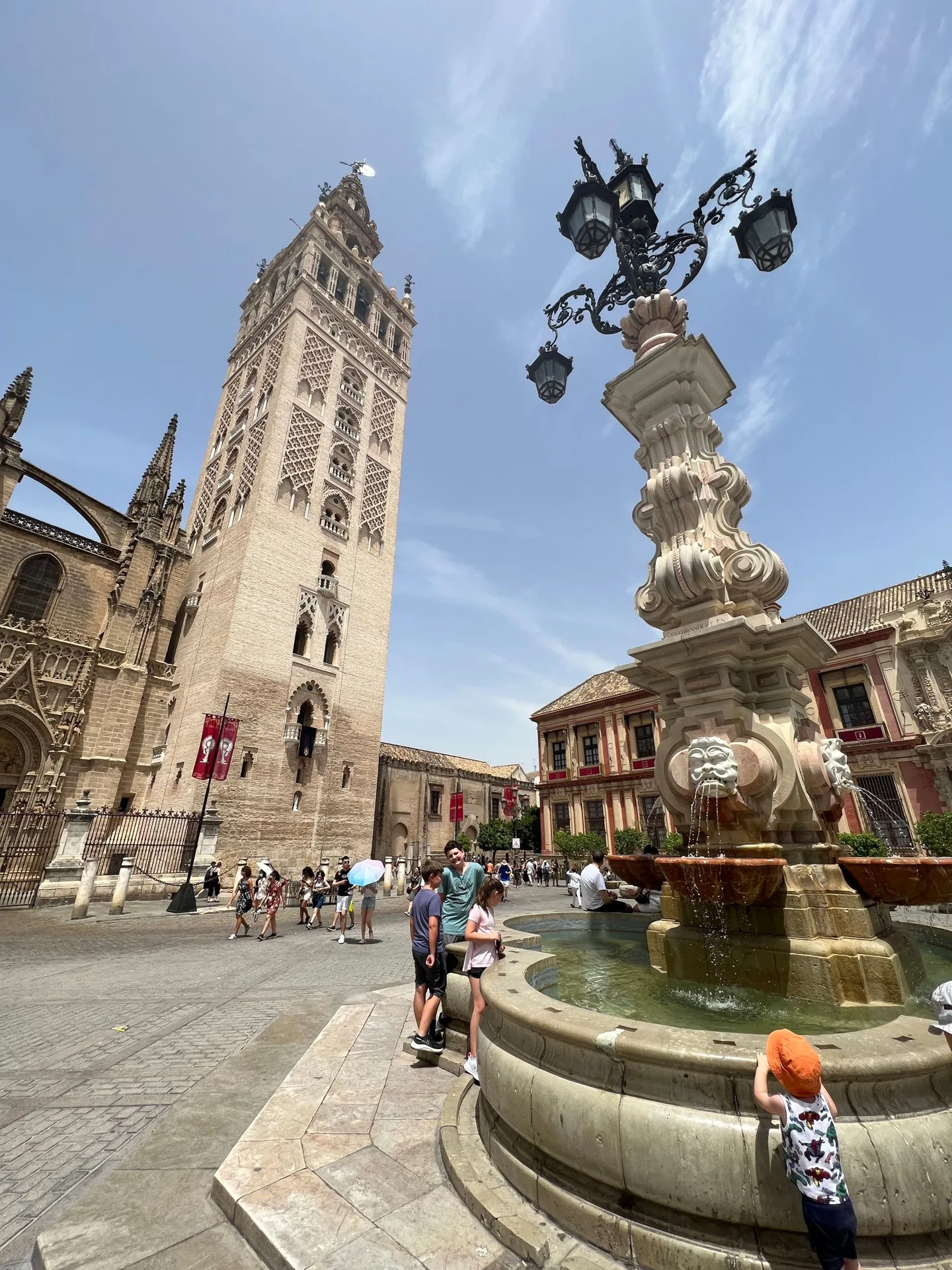 Ornate fountain and historic buildings in Seville
