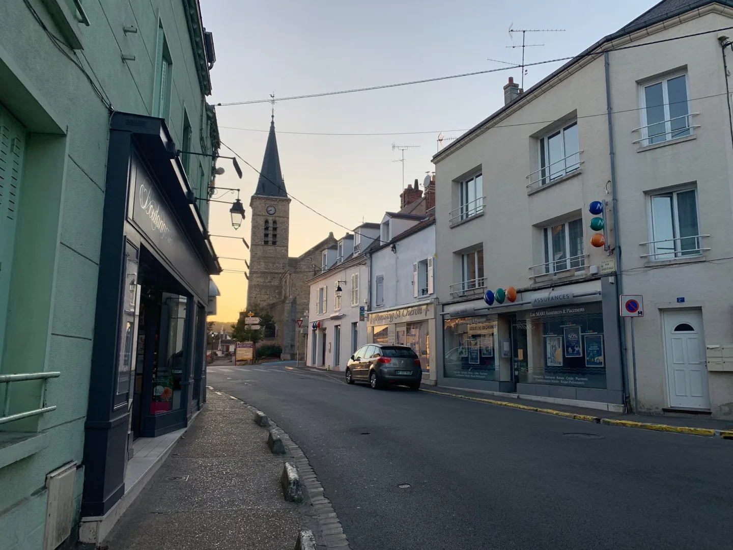 Narrow street leading toward a church