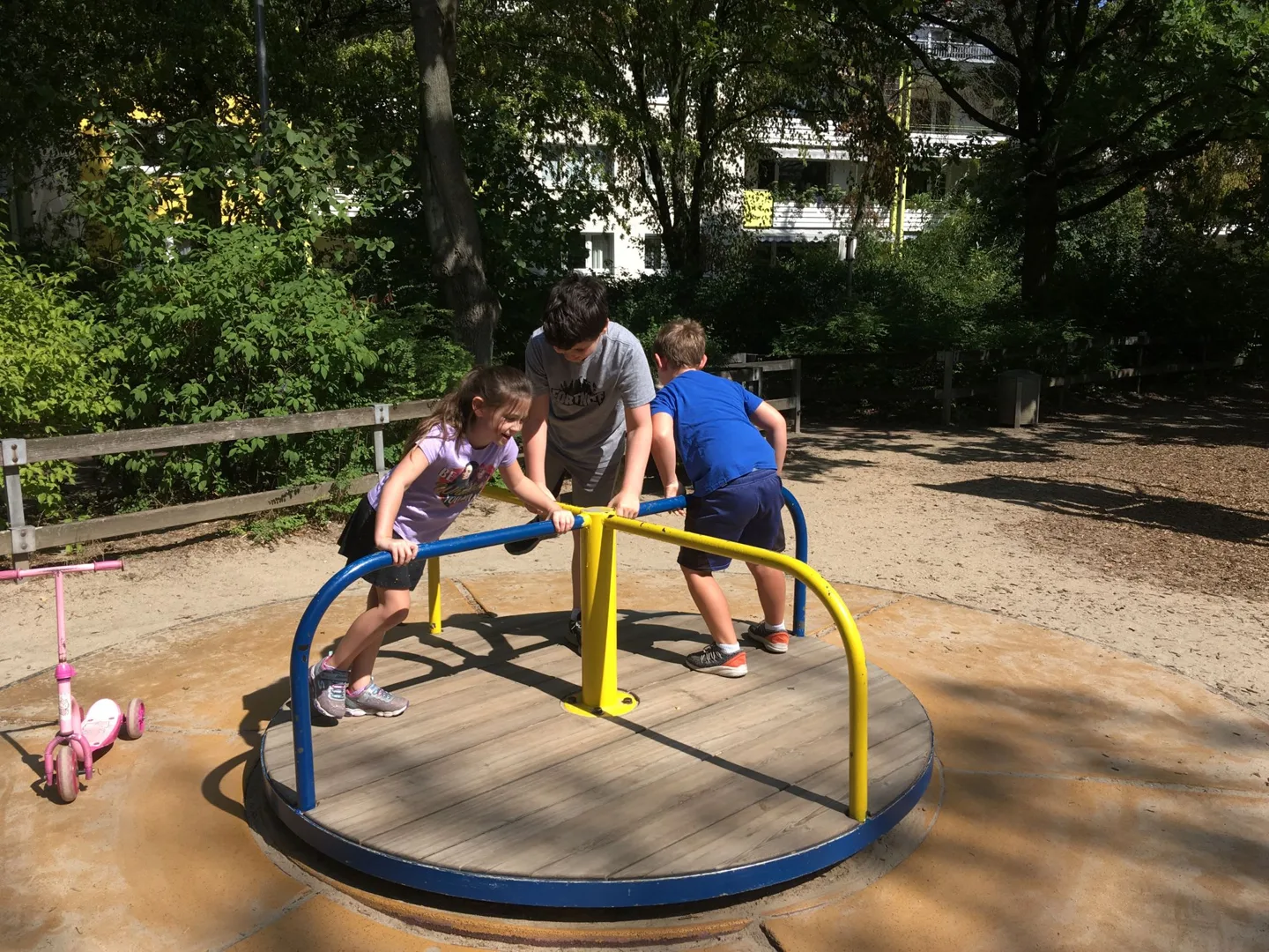 Children riding a playground roundabout