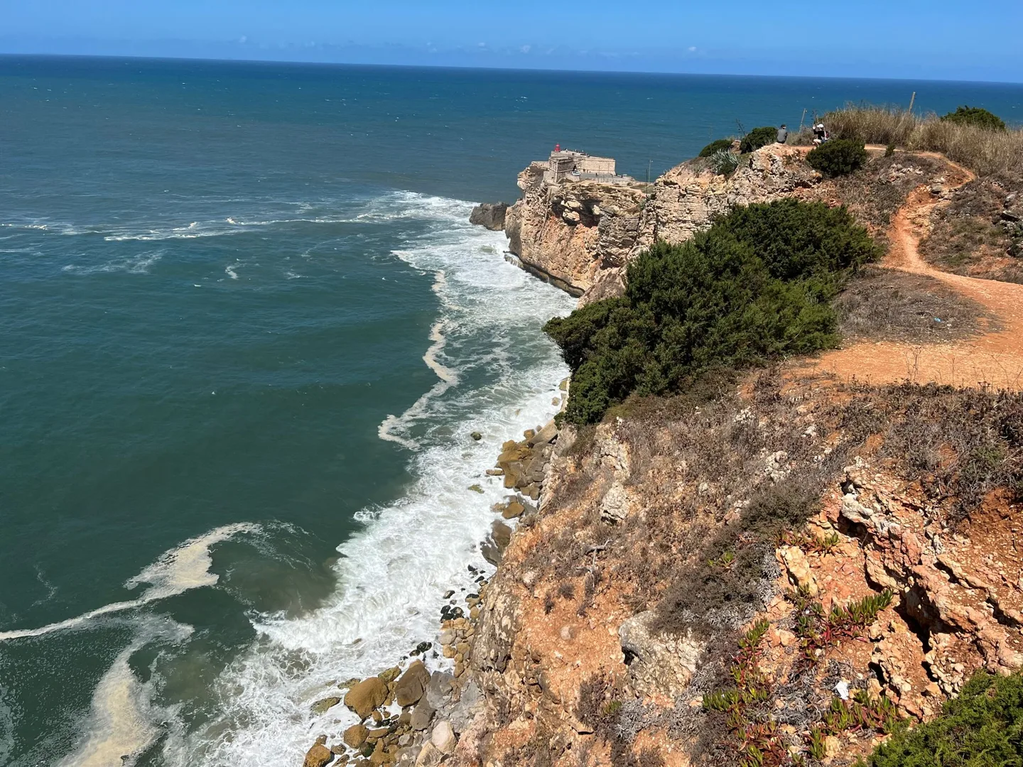 Waves breaking below rocky cliffs