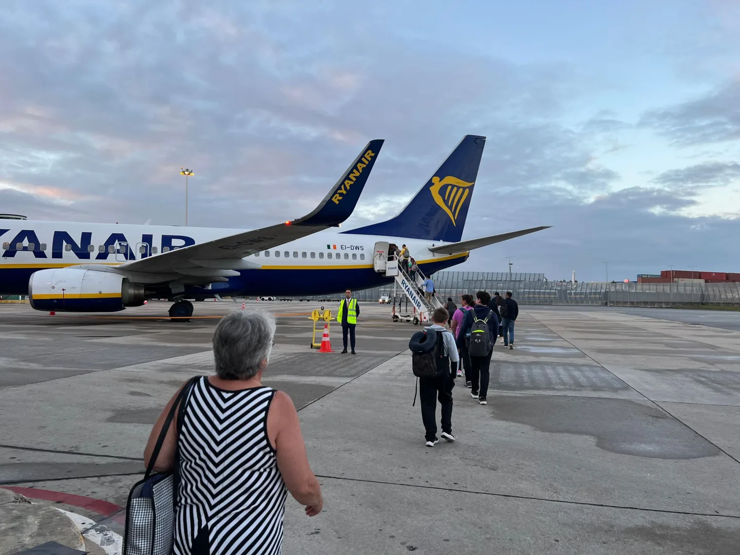 Passengers walking toward a Ryanair aircraft