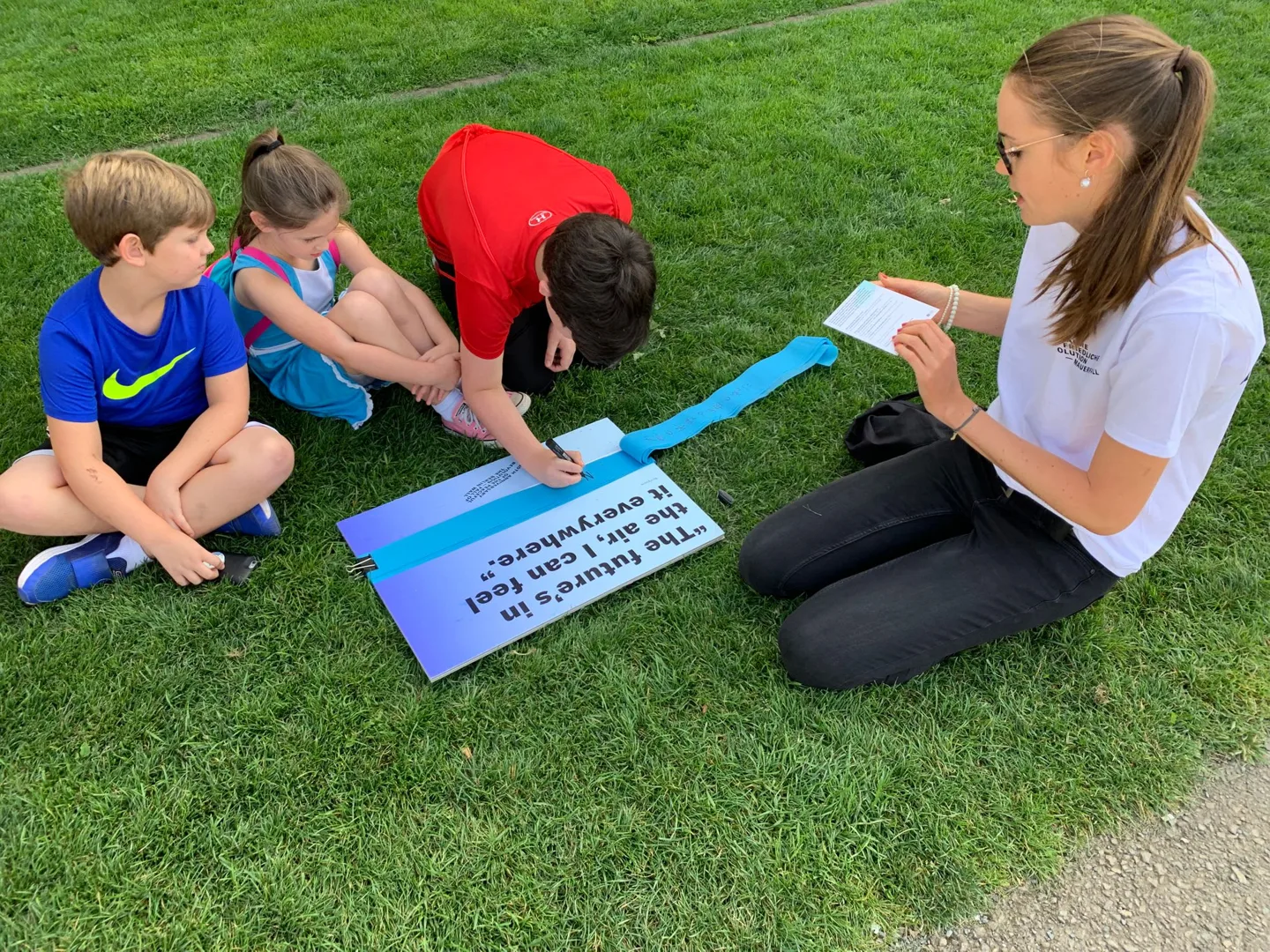 Family reading together on the grass