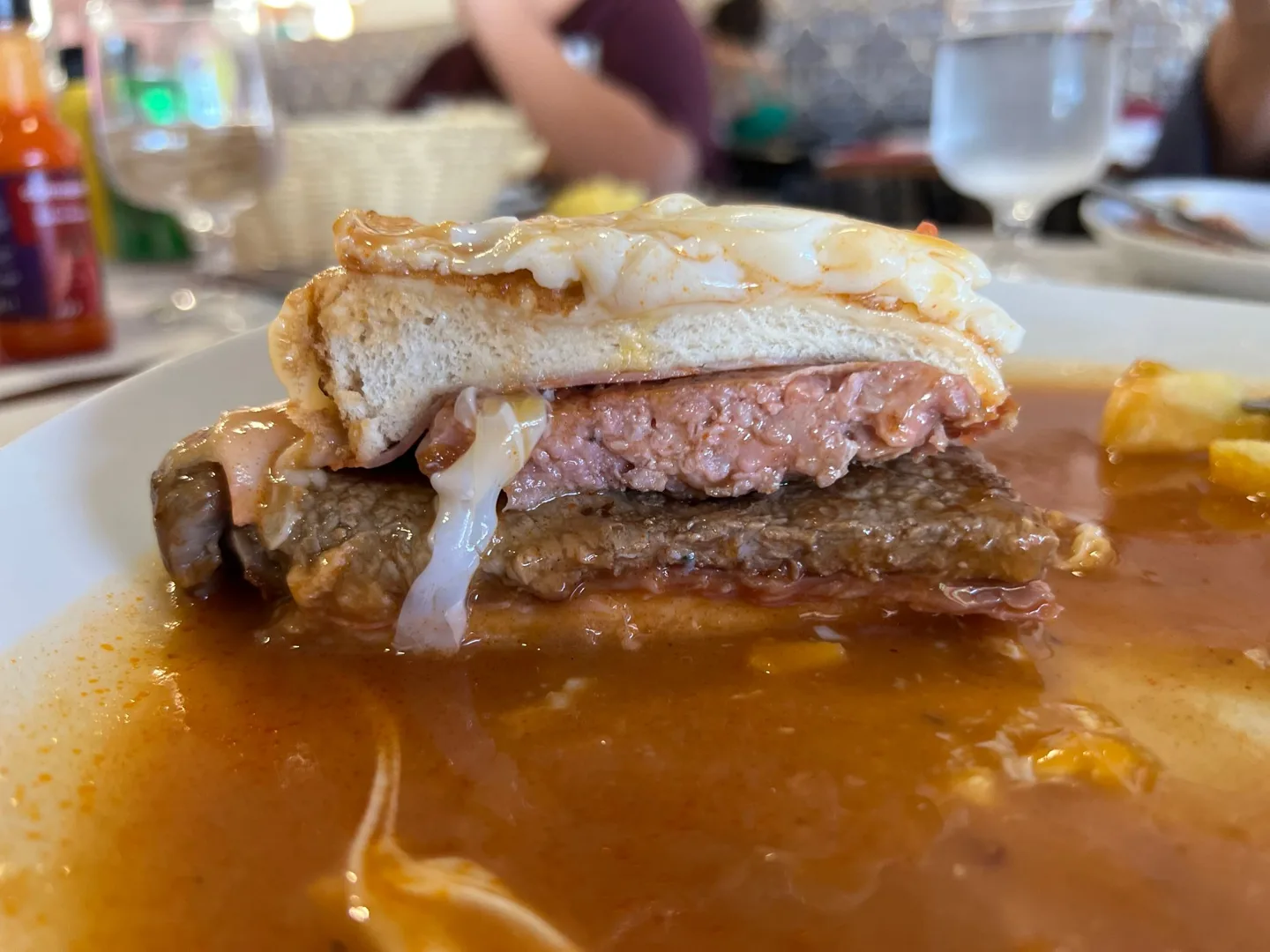 Sandwich with meat and cheese in sauce
