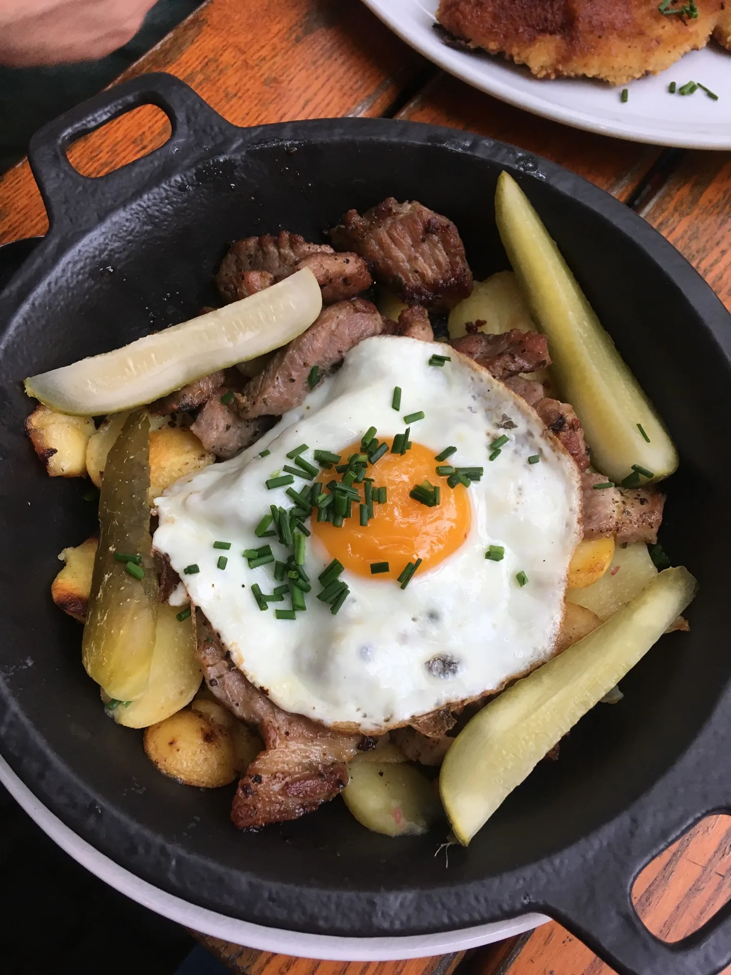 Skillet of potatoes topped with a fried egg