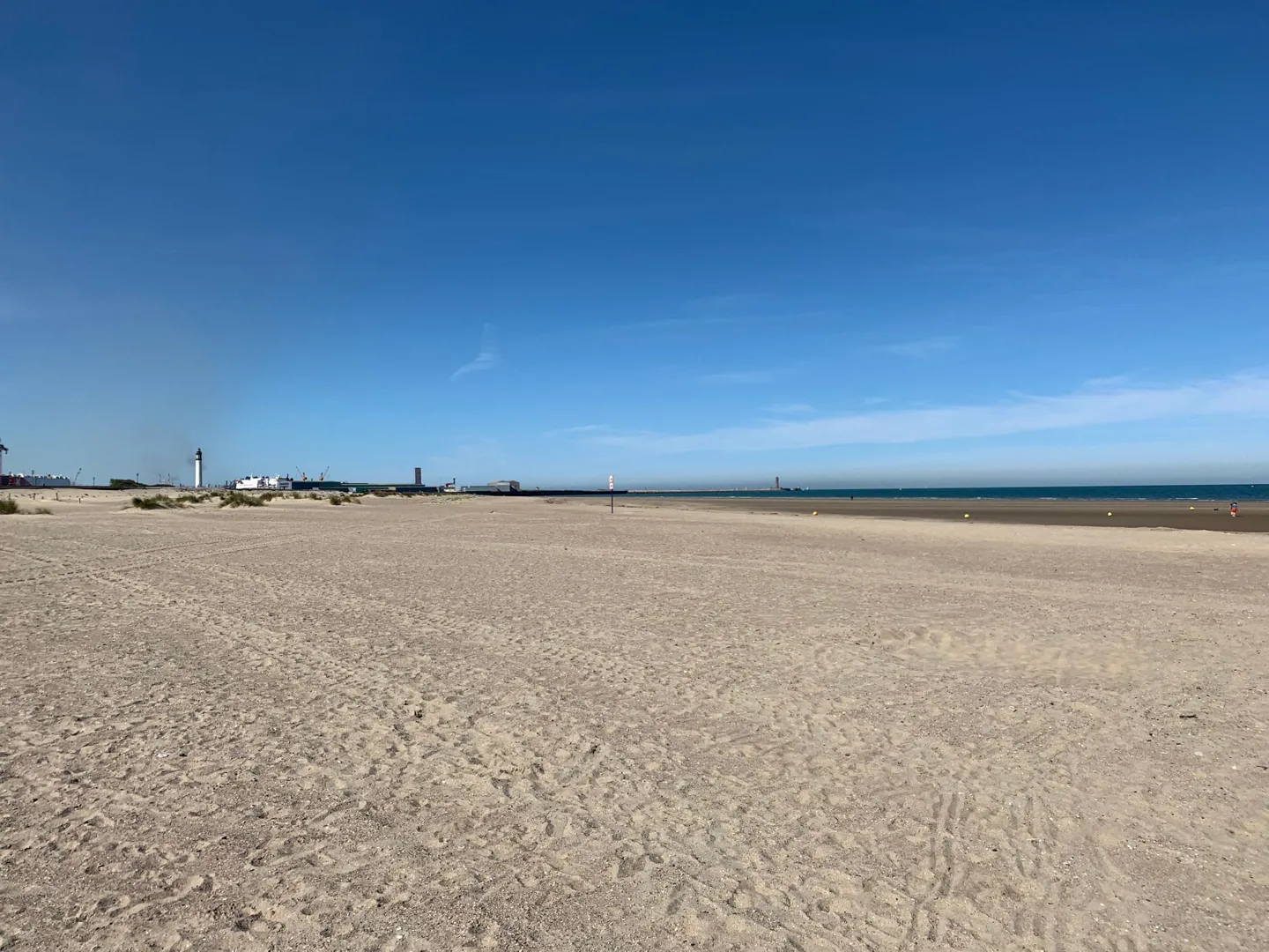 Wide sandy beach under a clear blue sky