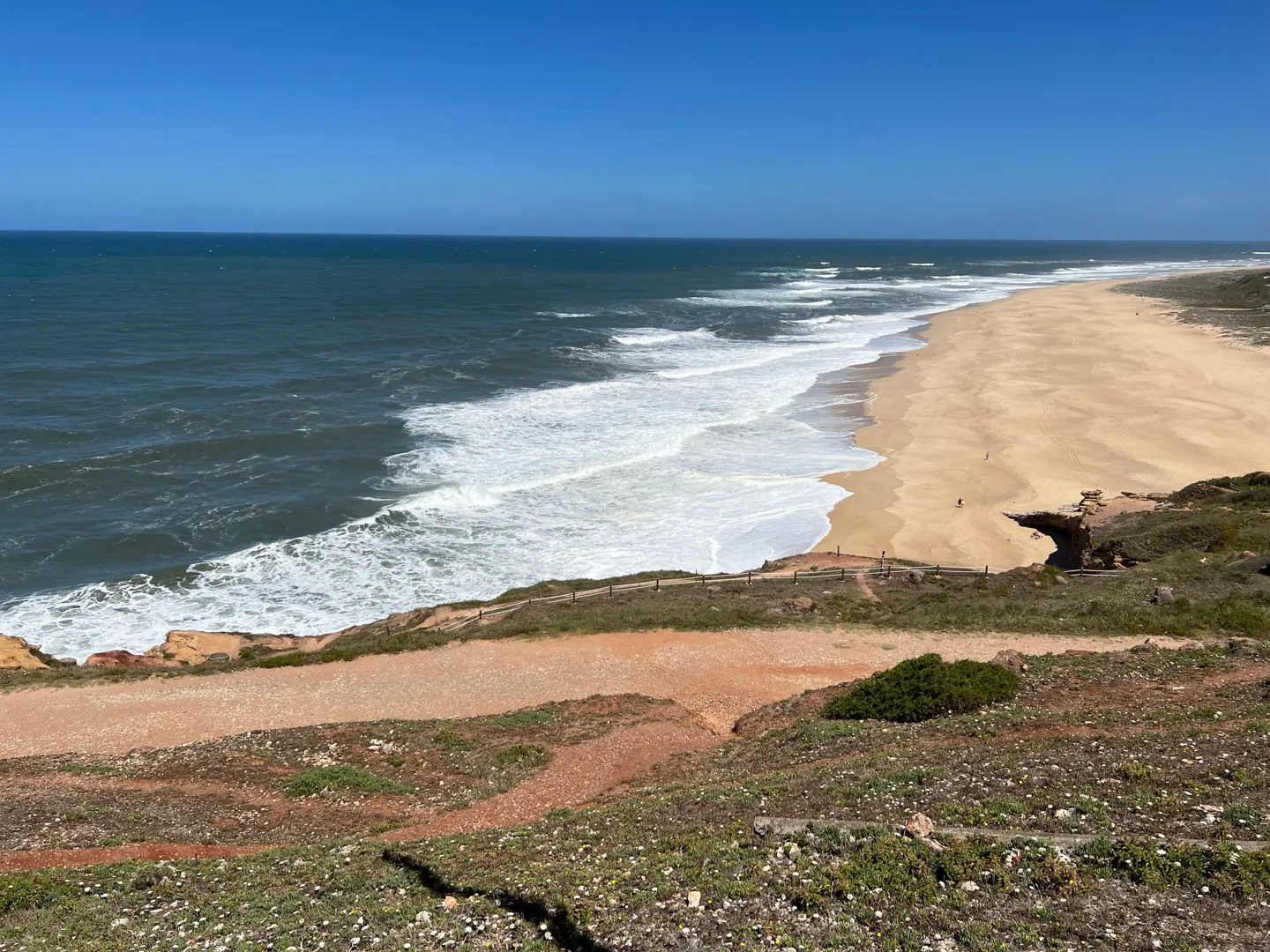 Surf washing onto a broad sandy beach