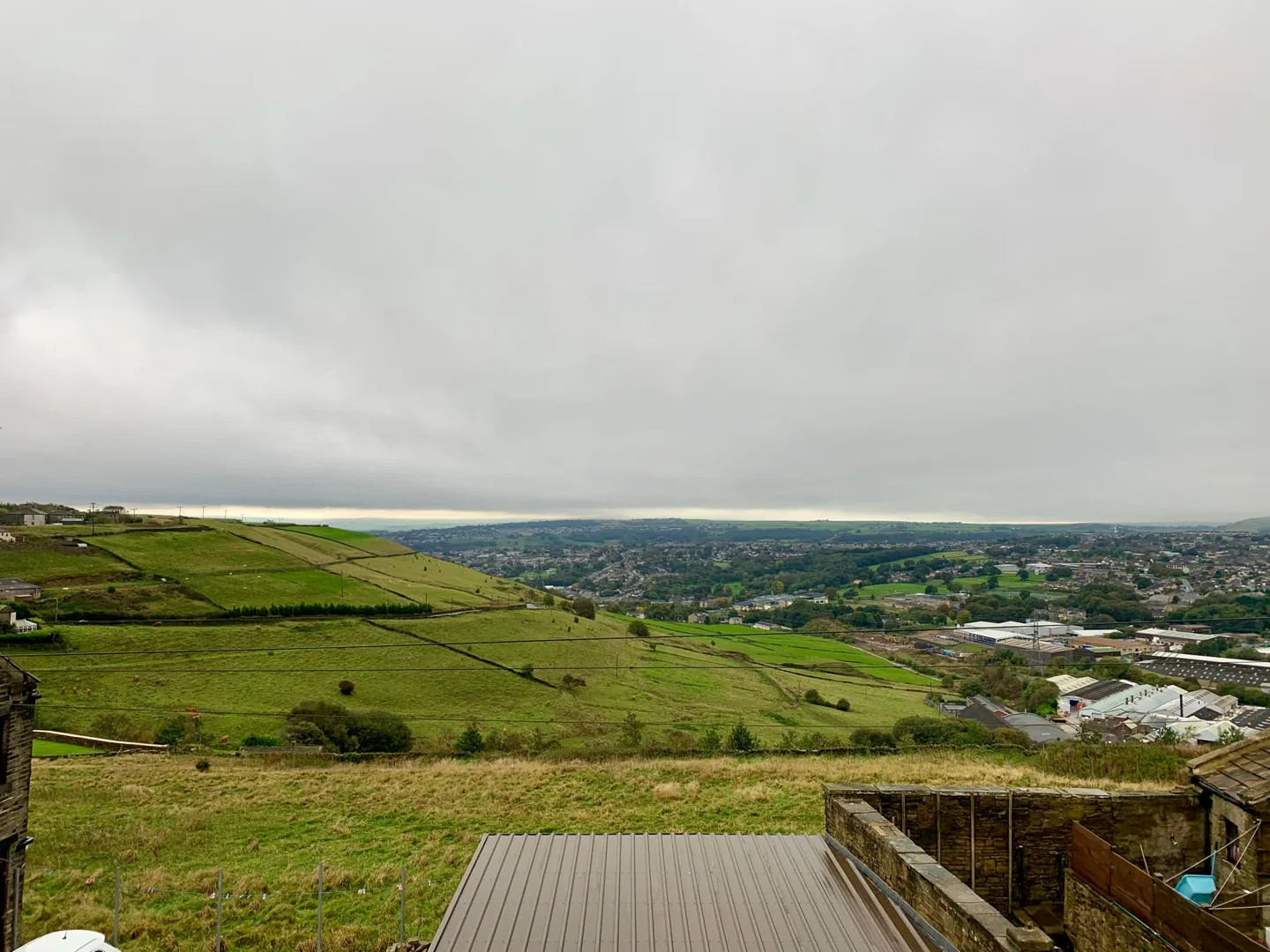 Hills and fields beneath an overcast sky