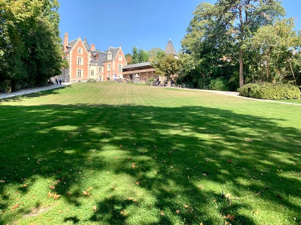 Château beyond a sunny lawn