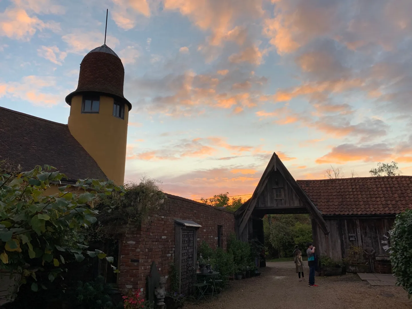 Tower and rooflines against a sunset sky