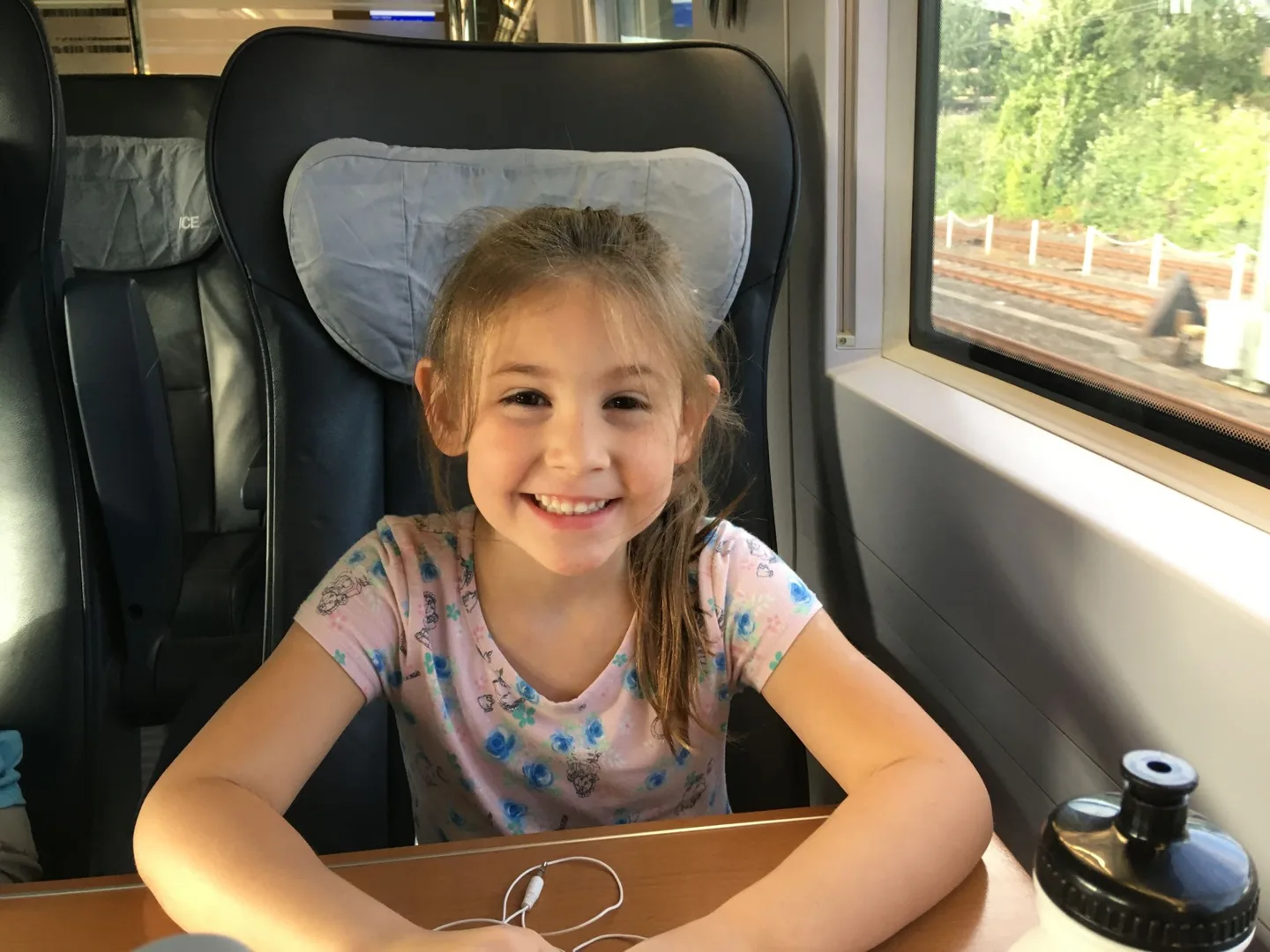 Child smiling from a train seat