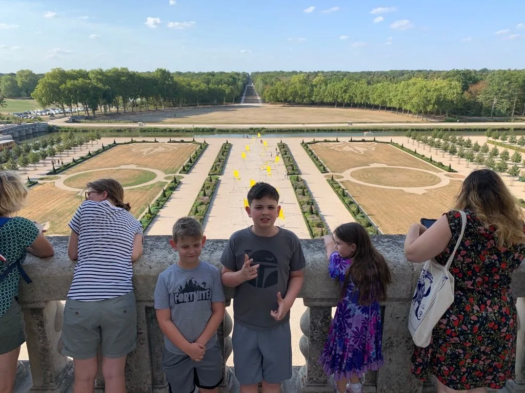 Family looking over the formal gardens at Chambord