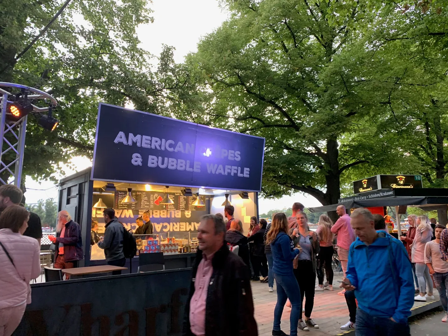 Food stall and crowds at an outdoor festival
