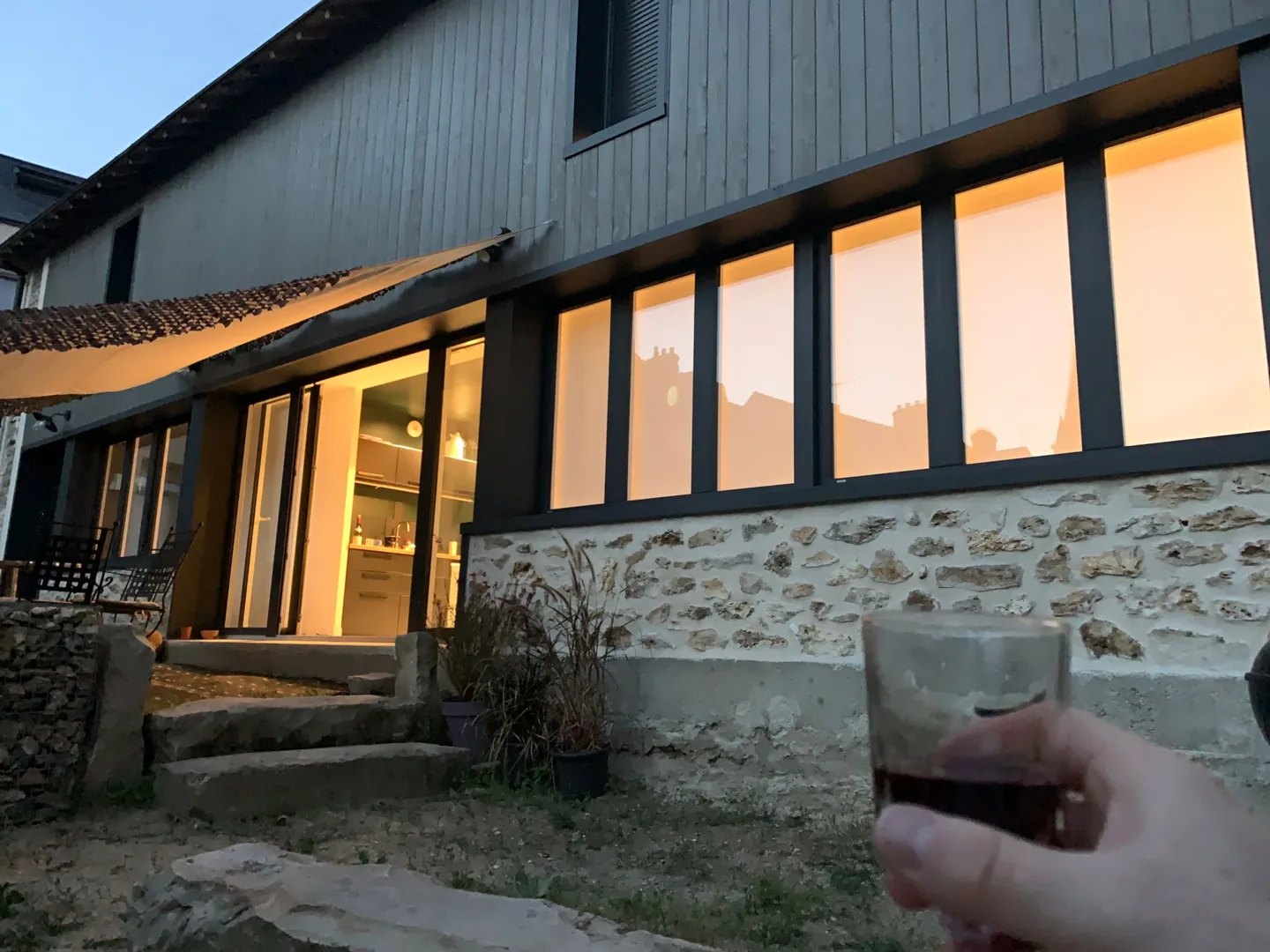 Drink outside a stone cottage at sunset