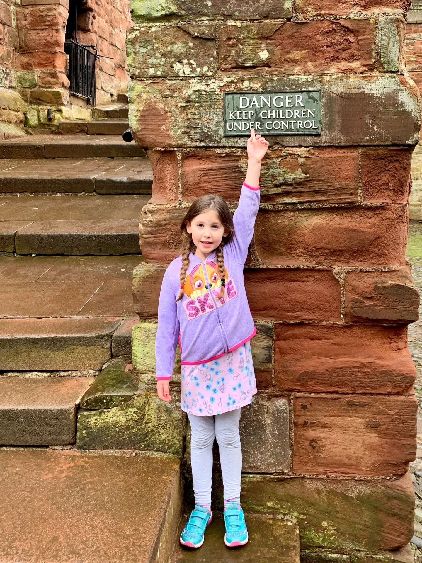 Child beside a castle doorway