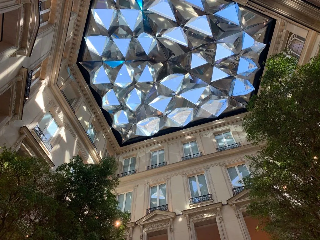 Geometric glass ceiling above an indoor courtyard