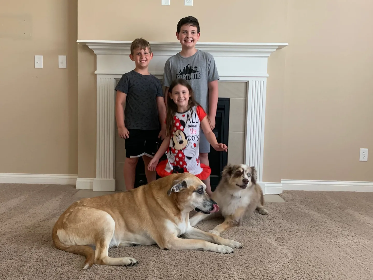 Children and dogs gathered by the fireplace before moving out