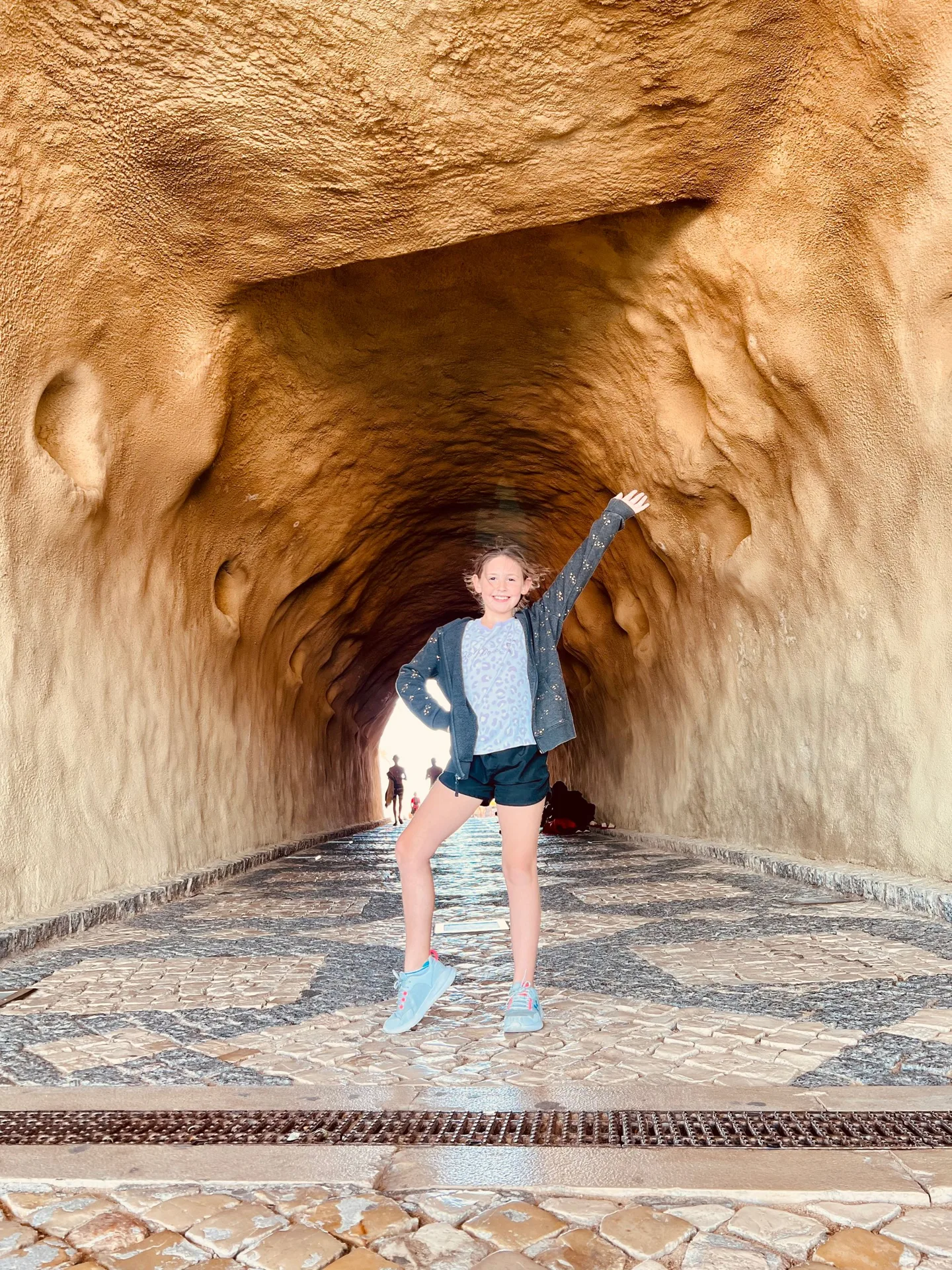 Child in a tunnel carved through orange rock