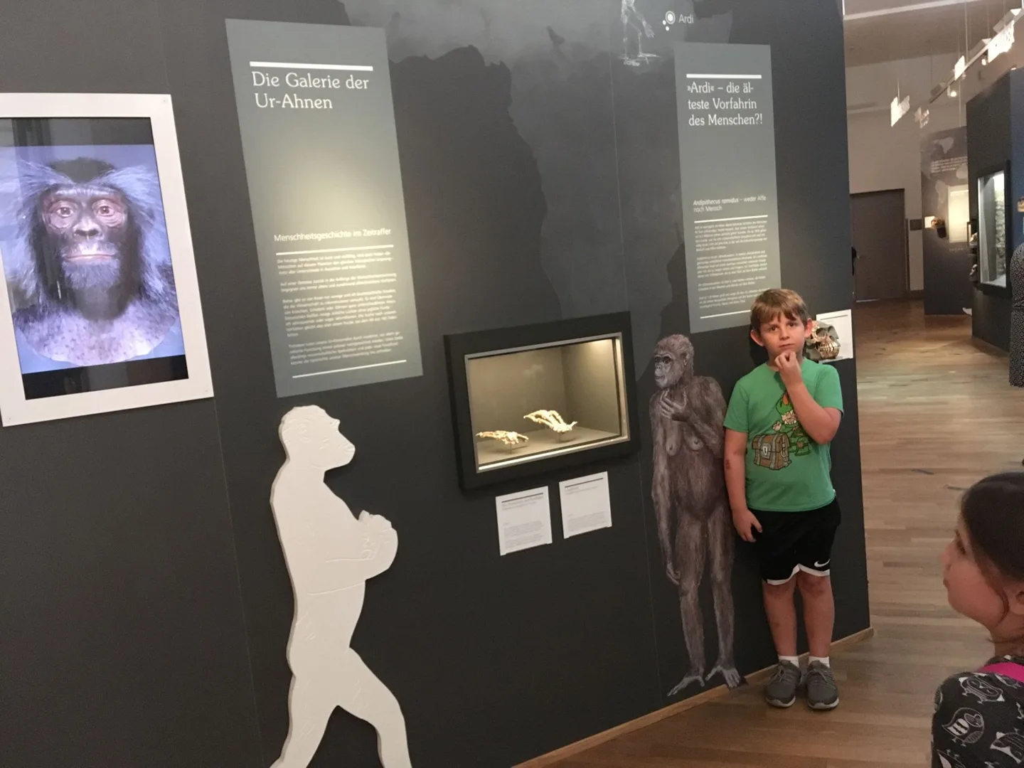 Child beside an interactive museum exhibit