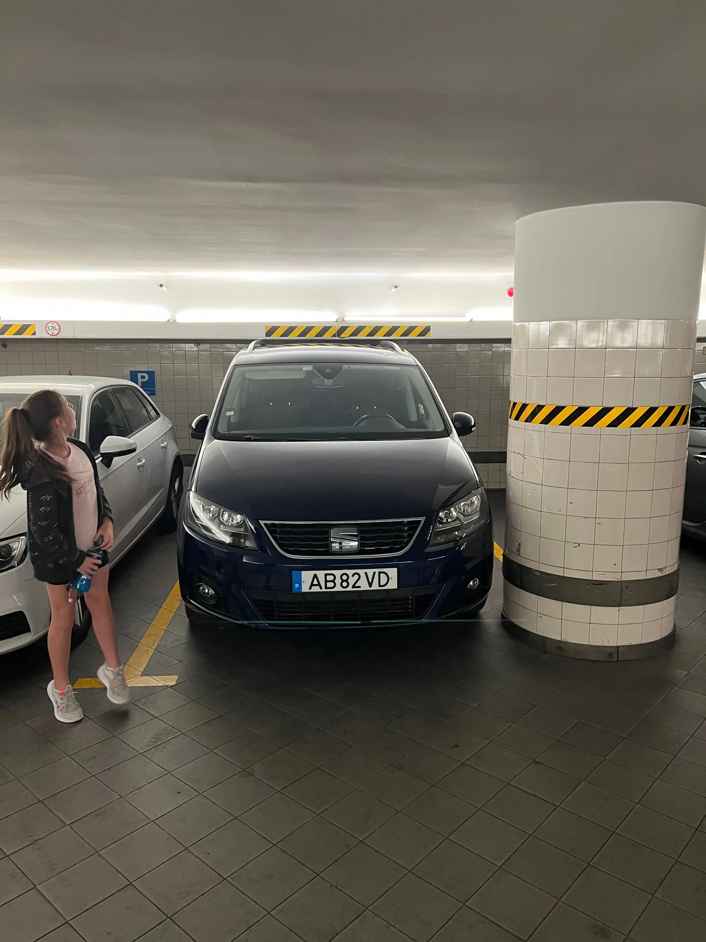 Family beside the van in a parking garage