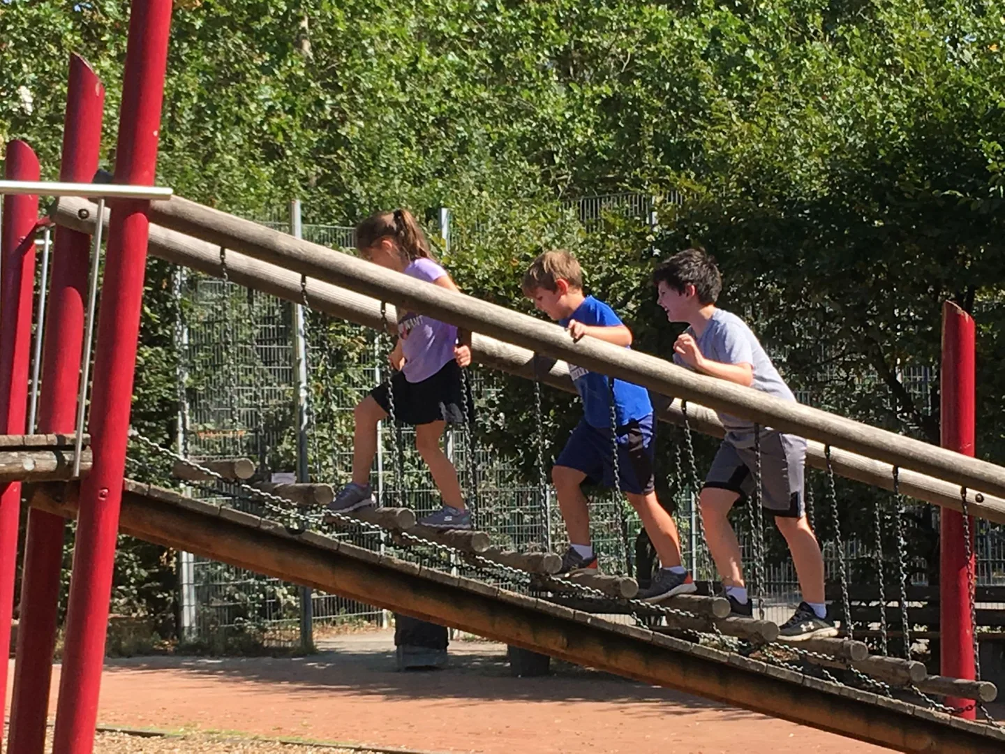 Children crossing a playground bridge
