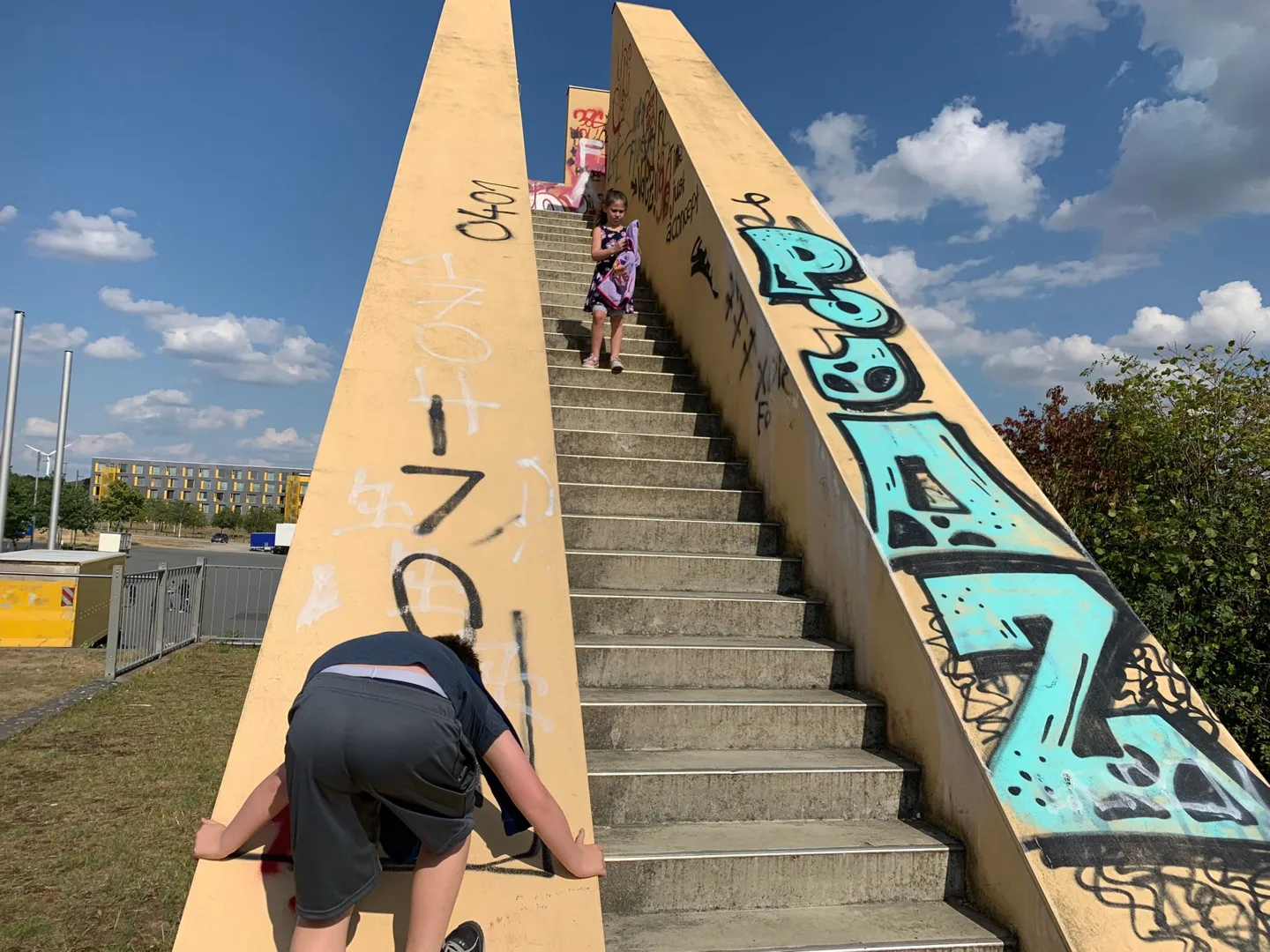 Child climbing a steep outdoor staircase