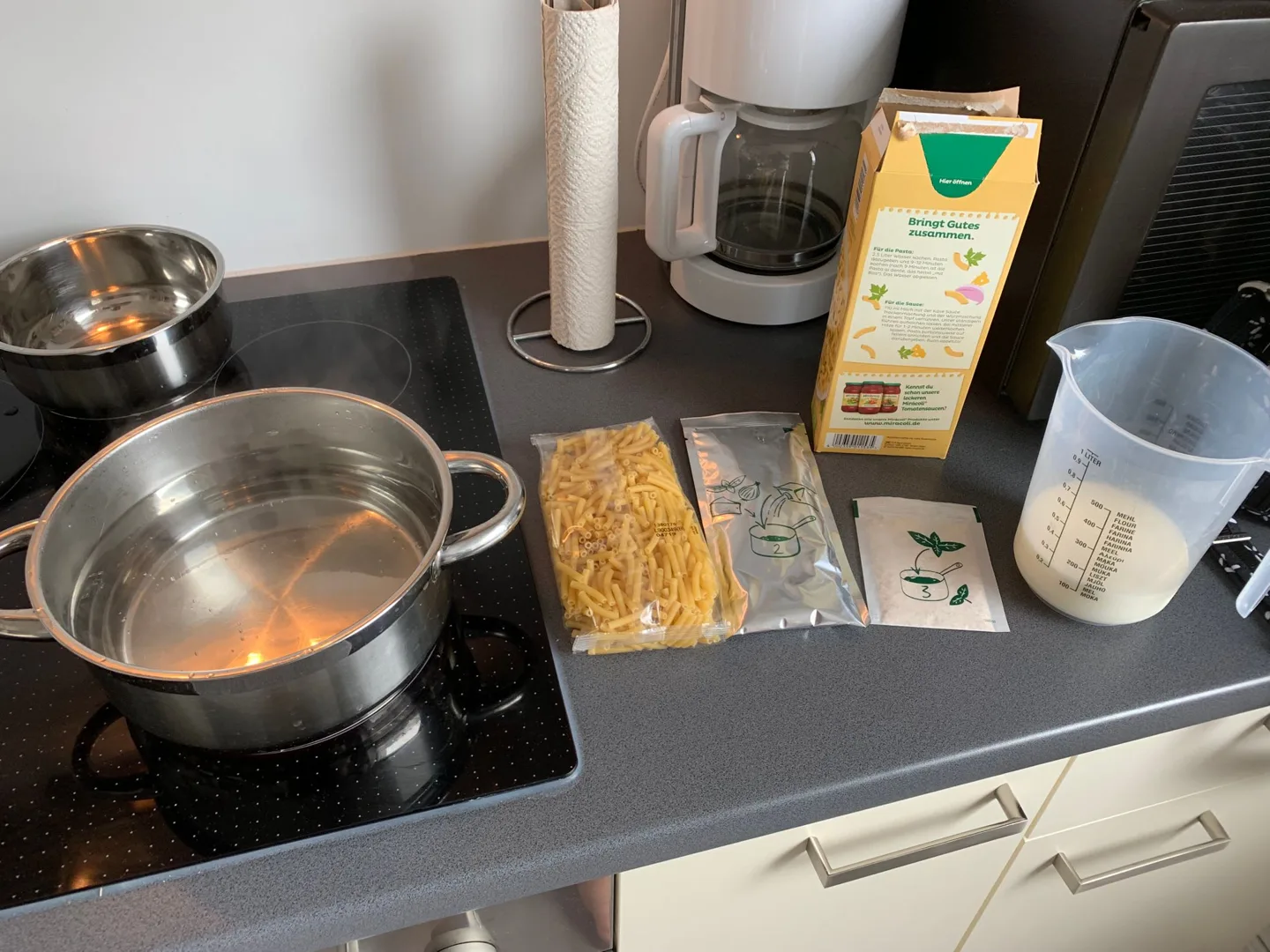 Pots, ingredients, and utensils on a kitchen counter