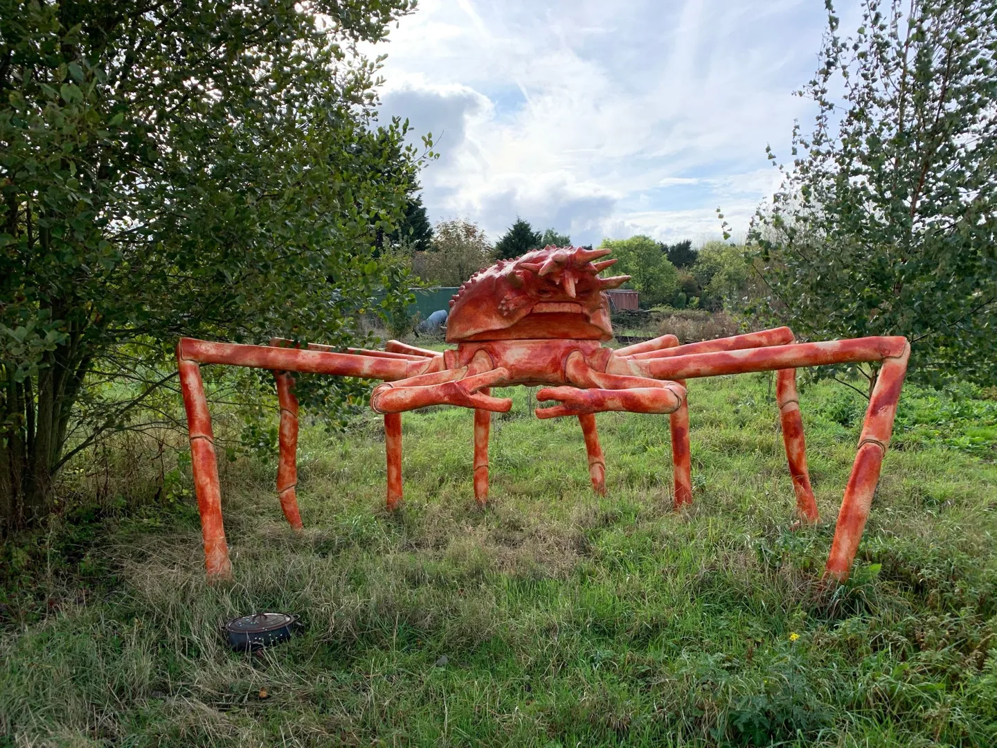Red sculpture standing in a garden
